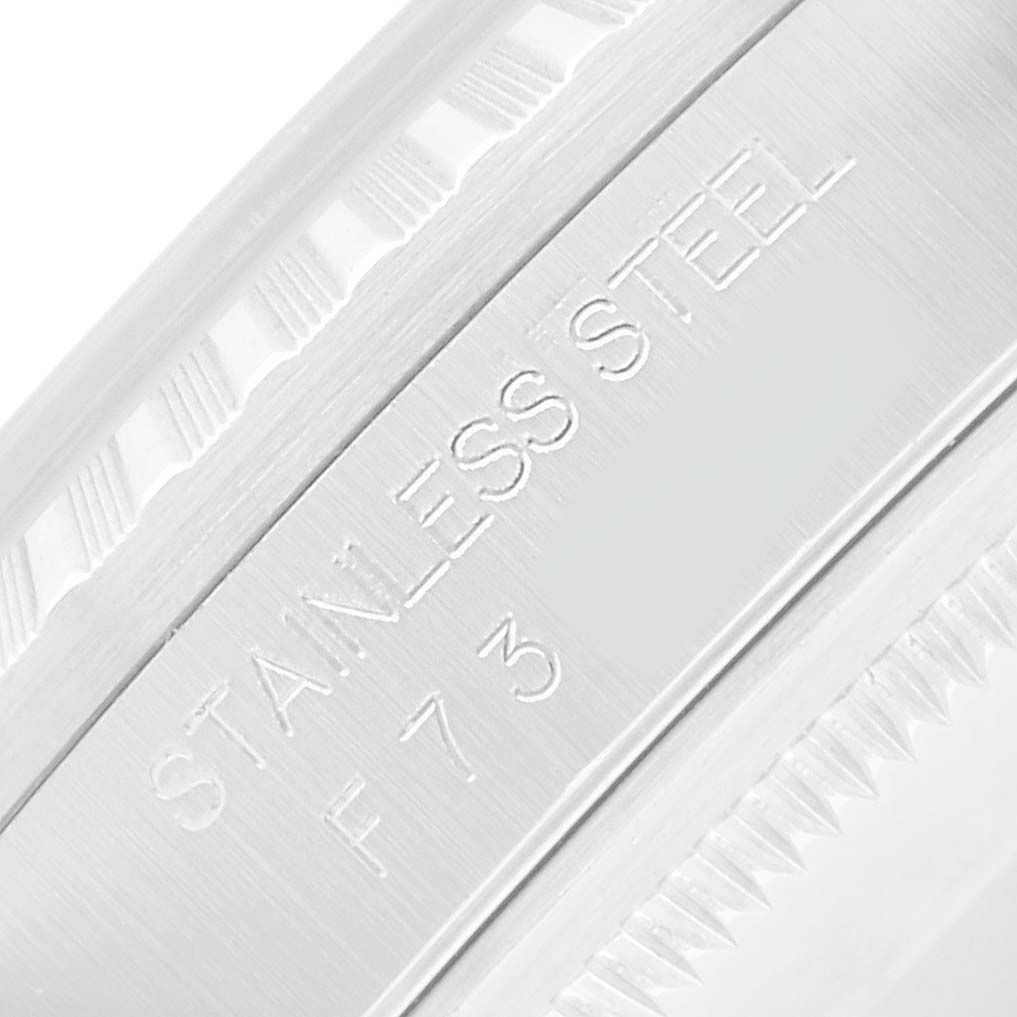 The image shows a close-up of the side engraving on a Rolex Datejust 16220 Men's Stainless Steel White Dial watch, highlighting "STAINLESS STEEL."