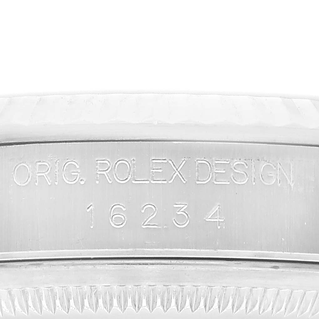 The image shows the engraved side of a Rolex Datejust 16234 Men's Stainless Steel White Dial 16234 Men's Stainless Steel White Dial's case, displaying "ORIG. ROLEX DESIGN 16234."