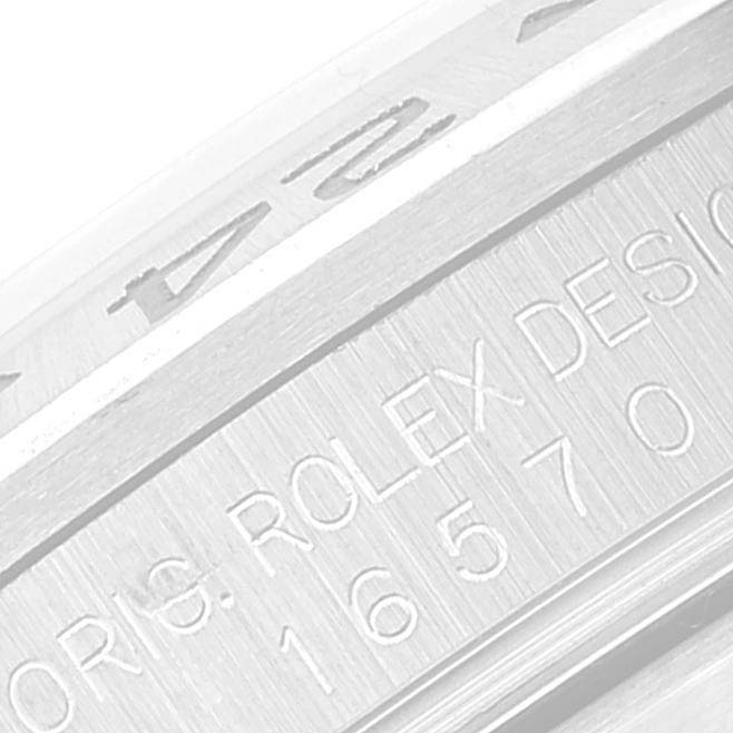 The image shows a close-up of the Rolex Explorer 16570 Men's Stainless Steel White Dial 16570 Men's Stainless Steel White Dial model 16570 watch, focusing on the engraved bezel and outer casing.