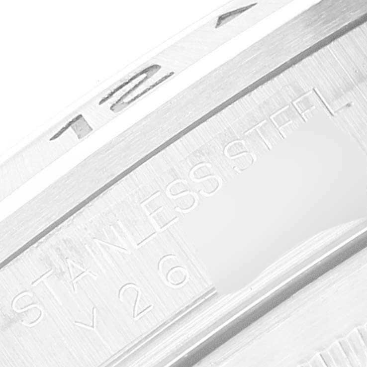 This close-up image shows the engraved "STAINLESS STEEL" text on the edge of a Rolex Explorer 16570 Men's Stainless Steel White Dial 16570 Men's Stainless Steel White Dial model watch.