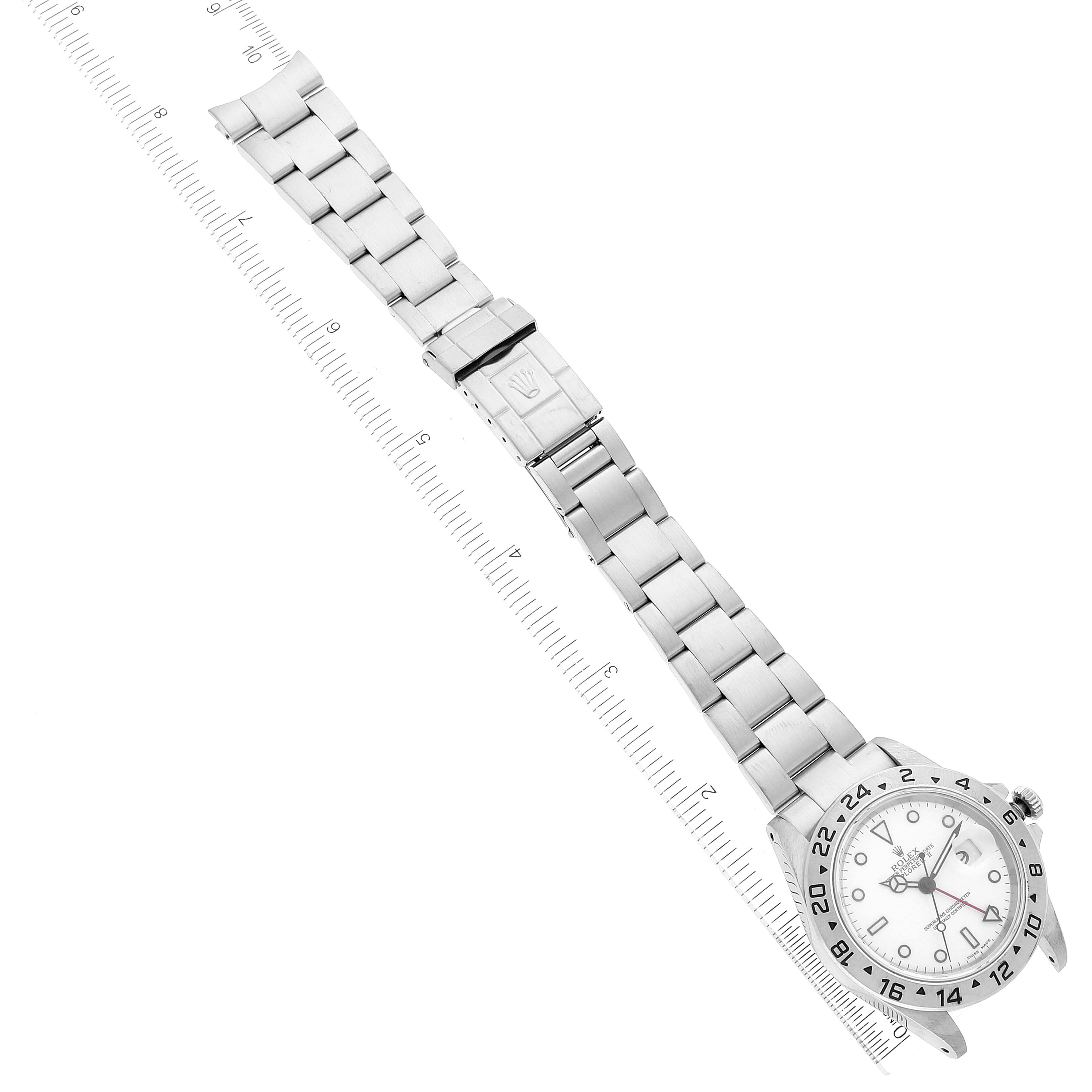 The image shows a Rolex Explorer 16570 Men's Stainless Steel White Dial 16570 Men's Stainless Steel White Dial watch with a white dial, GMT bezel, and stainless steel bracelet laid flat next to a ruler.