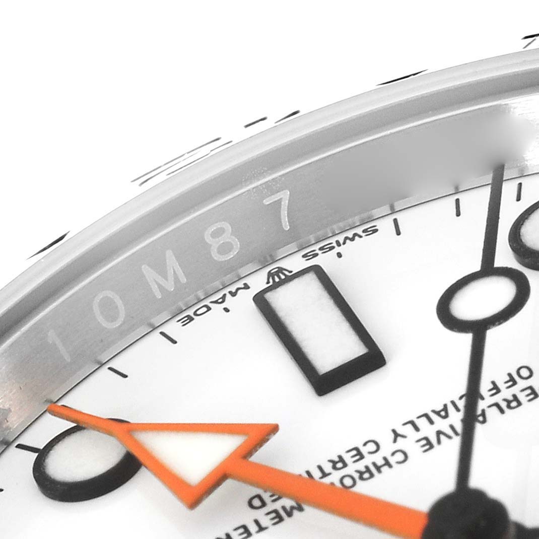 The image shows a close-up of the Rolex Explorer 226570 Men's Stainless Steel White Dial 226570 Men's Stainless Steel White Dial watch dial and bezel, highlighting the hands and some text.