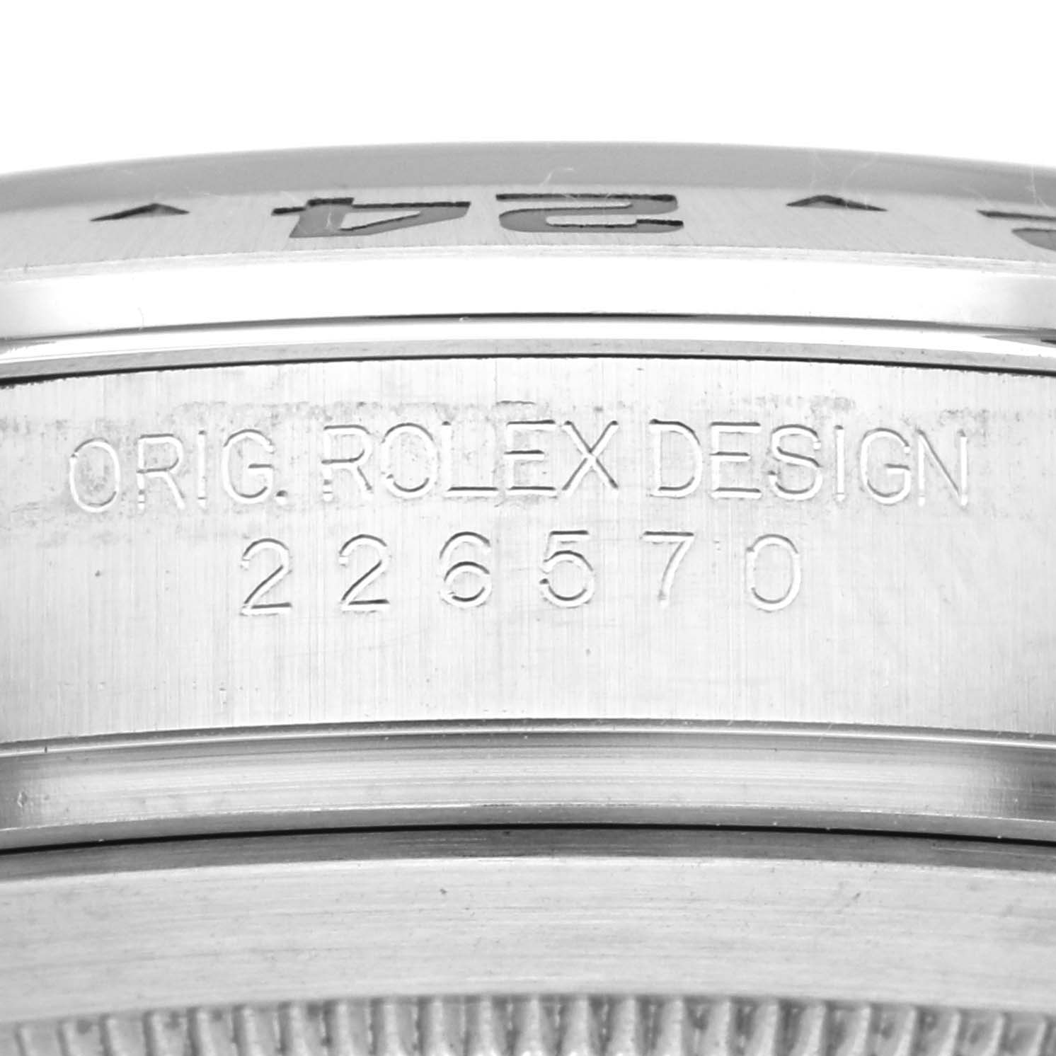 The image shows a close-up of the case side of a Rolex Explorer 226570 Men's Stainless Steel White Dial 226570 Men's Stainless Steel White Dial, displaying the serial number and "ORIG. ROLEX DESIGN" engraving.