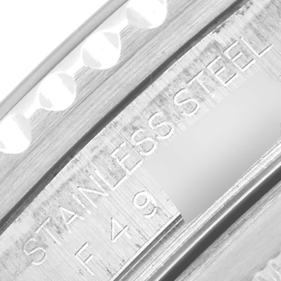 This close-up image of a Rolex GMT-Master 16710 Men
s Stainless Steel Black Dial 16710 Men
s Stainless Steel Black Dial model watch displays the stainless steel part with the engraving "STAINLESS STEEL F49."