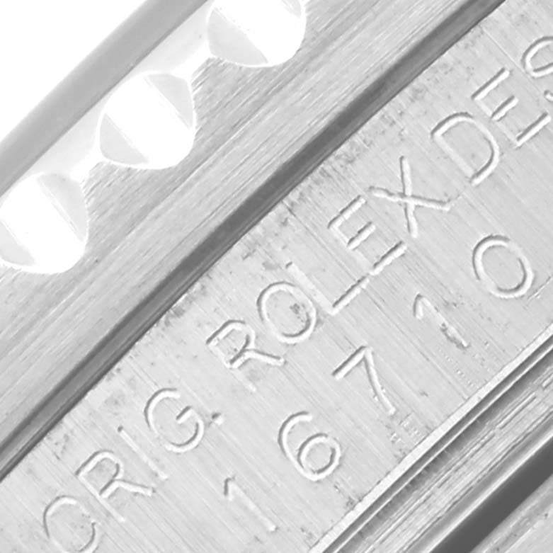 This close-up image shows the engraved side of the bezel and case of a Rolex GMT-Master 16710 Men
s Stainless Steel Black Dial 16710 Men
s Stainless Steel Black Dial model.