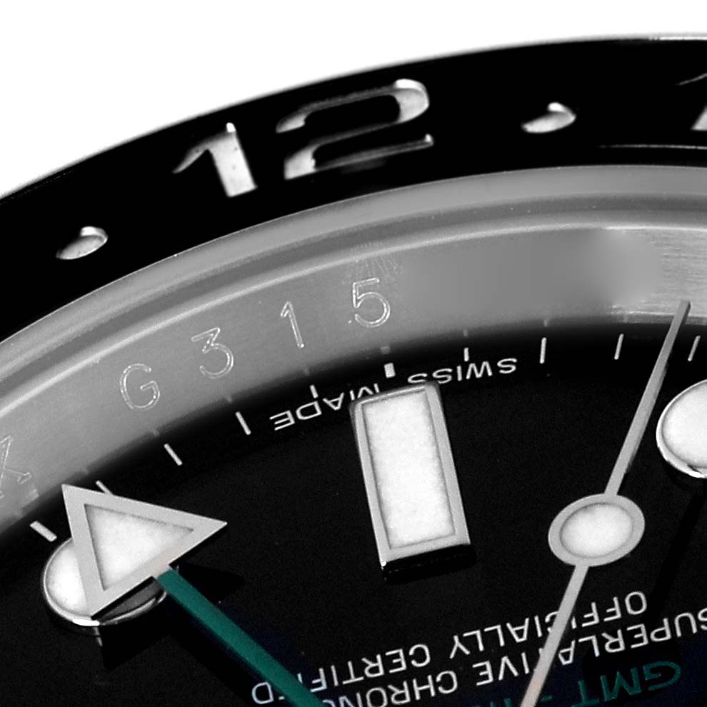 This image shows a close-up of the dial, bezel, and part of the hands of a Rolex GMT-Master 116710 Men's Stainless Steel Black Dial 116710 Men's Stainless Steel Black Dial watch.