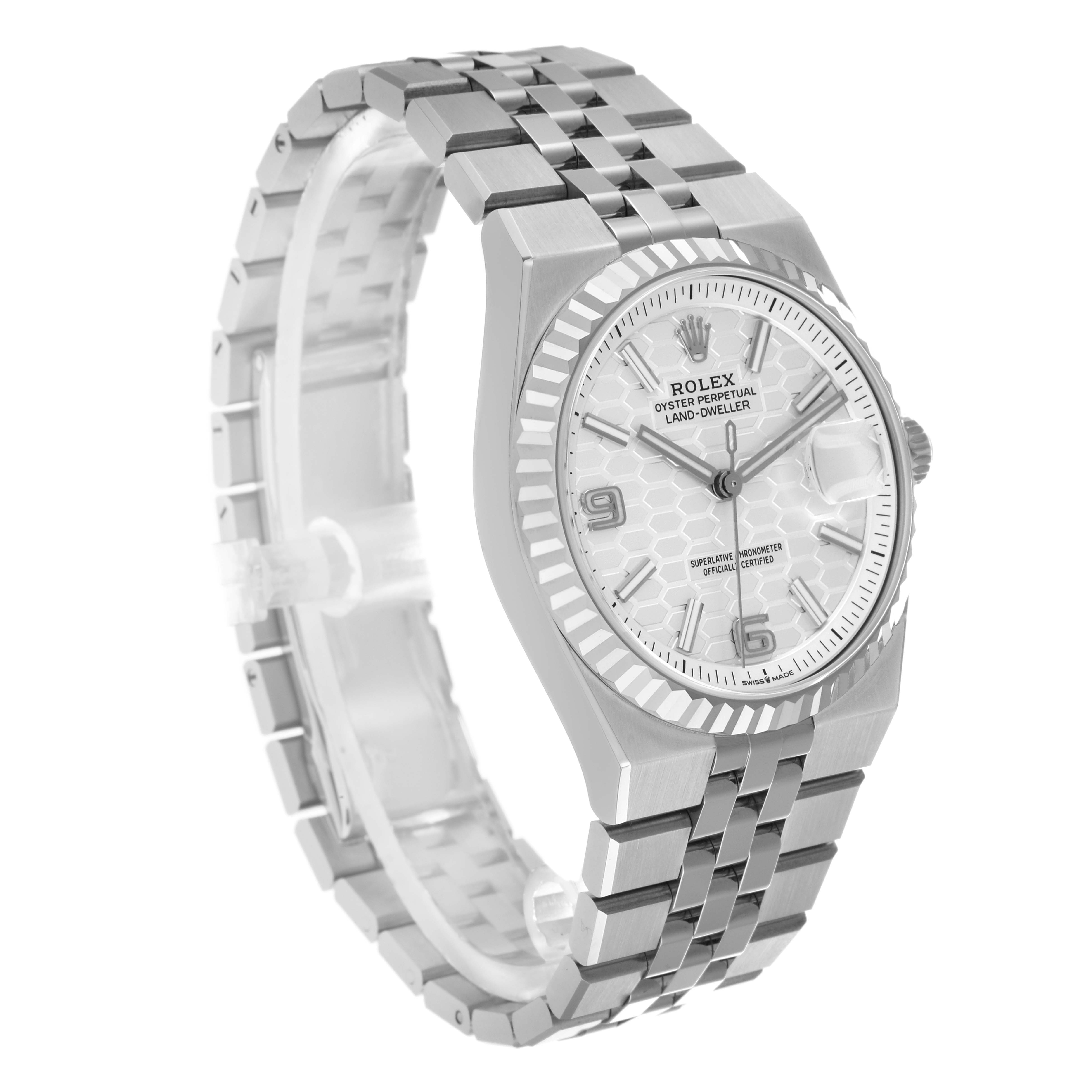 The Rolex Land-Dweller watch is shown at a three-quarter angle, displaying the face, bezel, and bracelet.