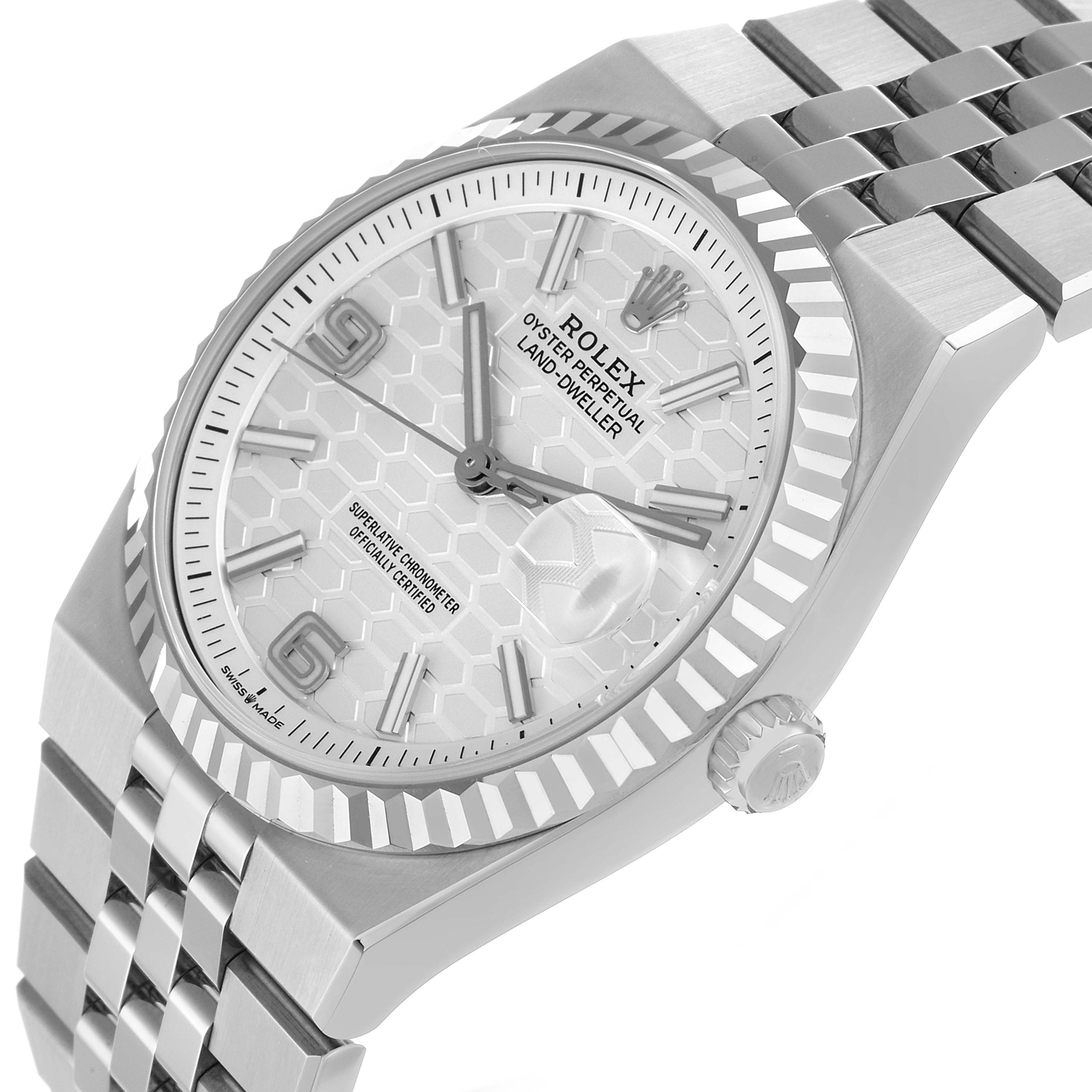 The Rolex Land-Dweller watch is shown at an angled view, highlighting the face, bezel, crown, and part of the bracelet.