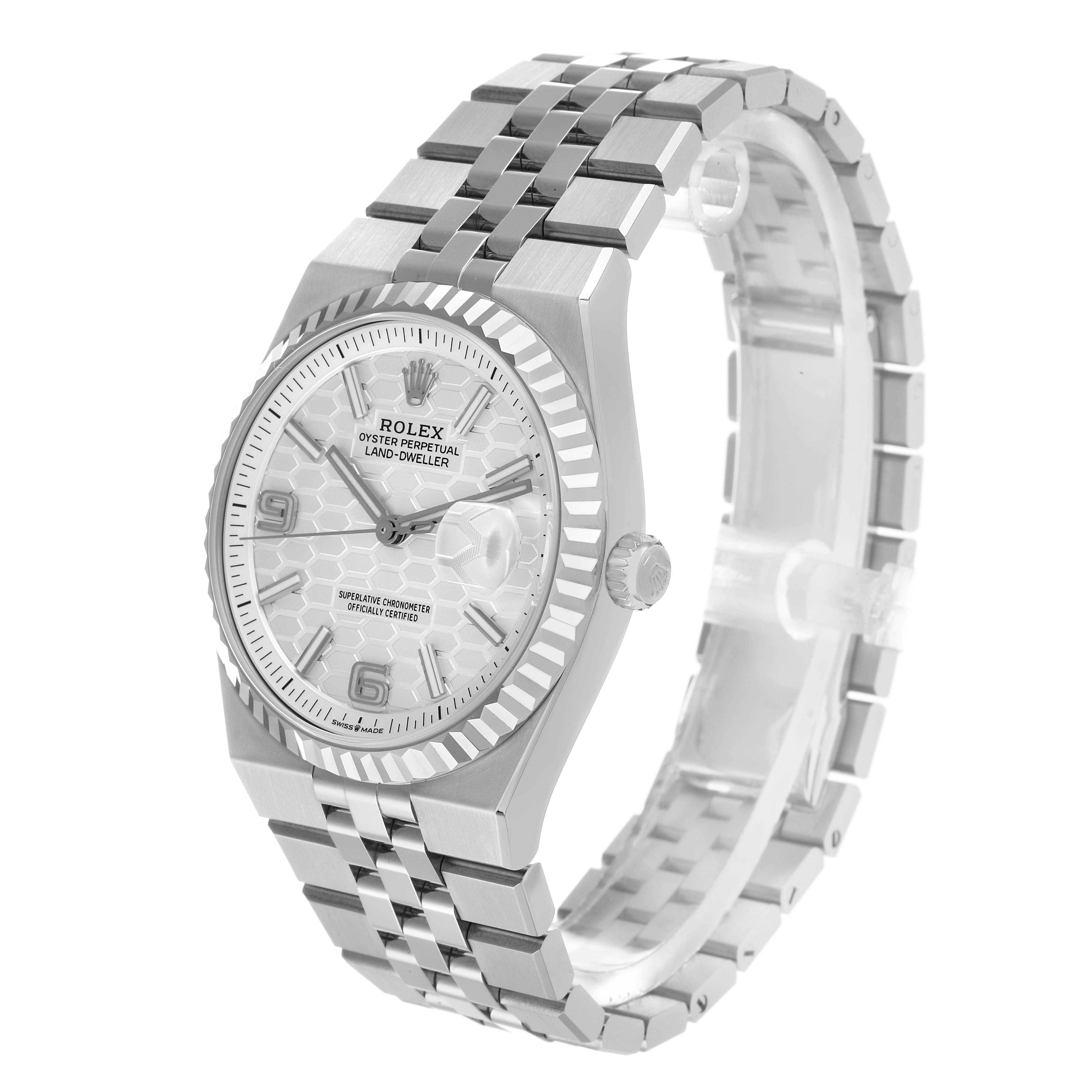 The Rolex Land-Dweller watch is shown at a front angle, highlighting its face, bezel, crown, and bracelet.