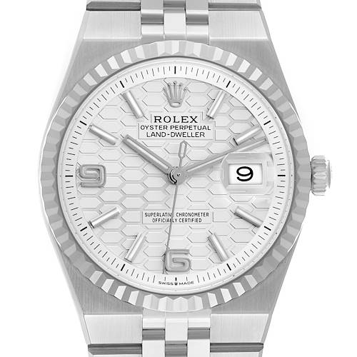 The Rolex Land-Dweller watch is shown from a front angle, displaying its dial, bezel, and part of the bracelet.