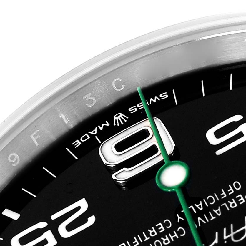 The image shows a close-up of the Rolex Air-King 126900 Men's Stainless Steel Black Dial watch dial with numerals, hands, and "Swiss Made" text visible.