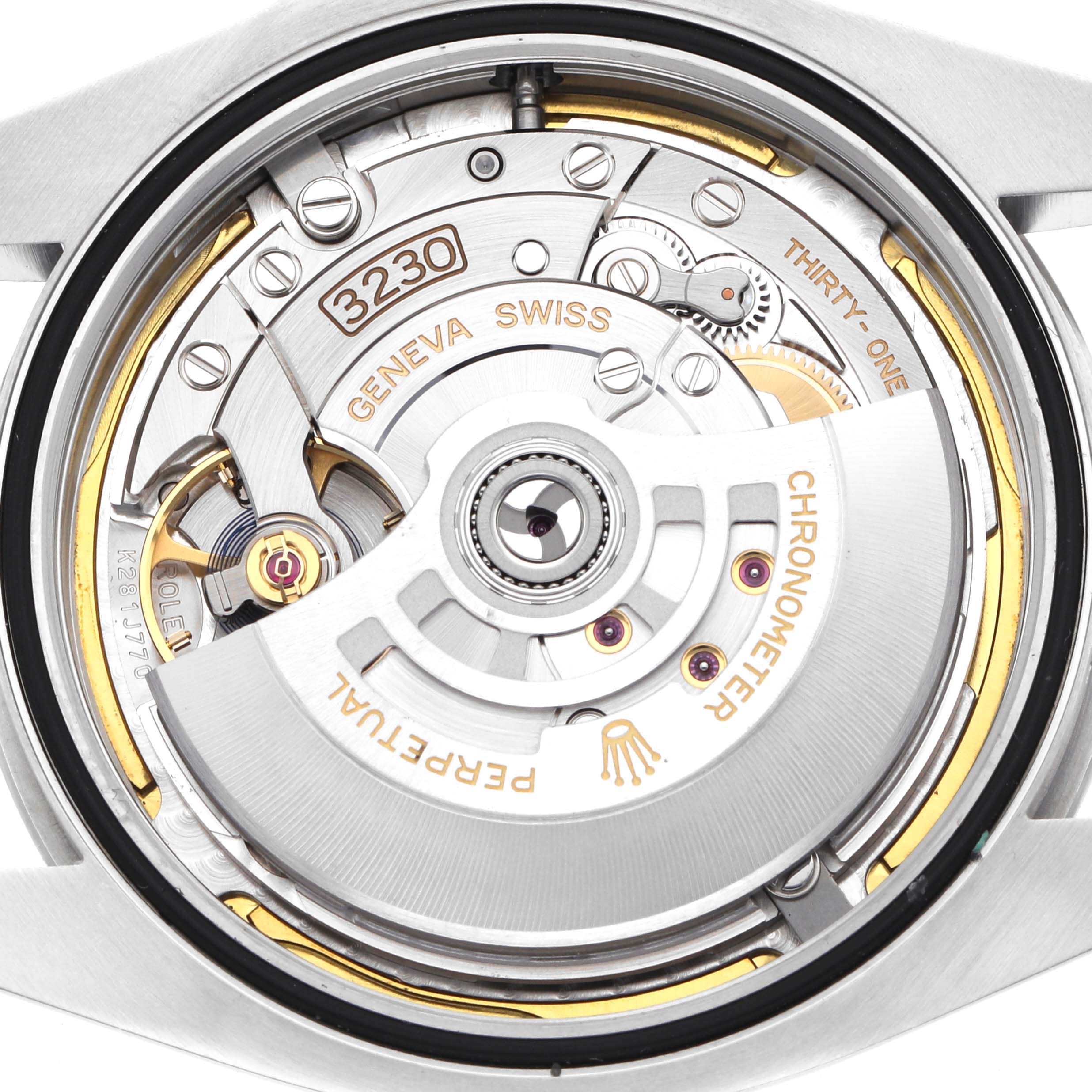 The image shows a close-up of the Rolex Air-King 126900 Men's Stainless Steel Black Dial's movement, highlighting its intricate mechanism from the back.