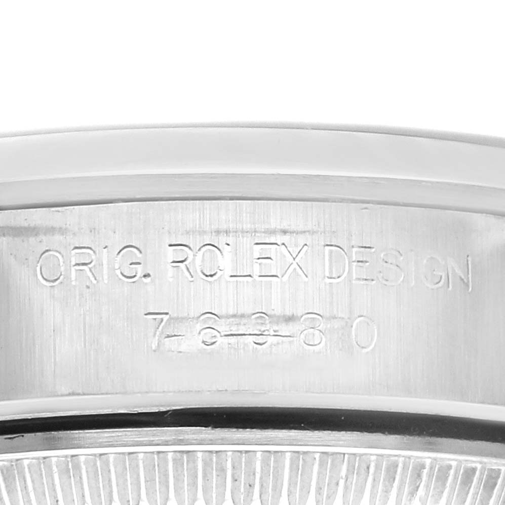 The image shows a close-up angle of the case side of the Rolex Oyster Perpetual 76080 Women's Stainless Steel Pink Dial 76080 Women's Stainless Steel Pink Dial, featuring the engraved serial number and design details.