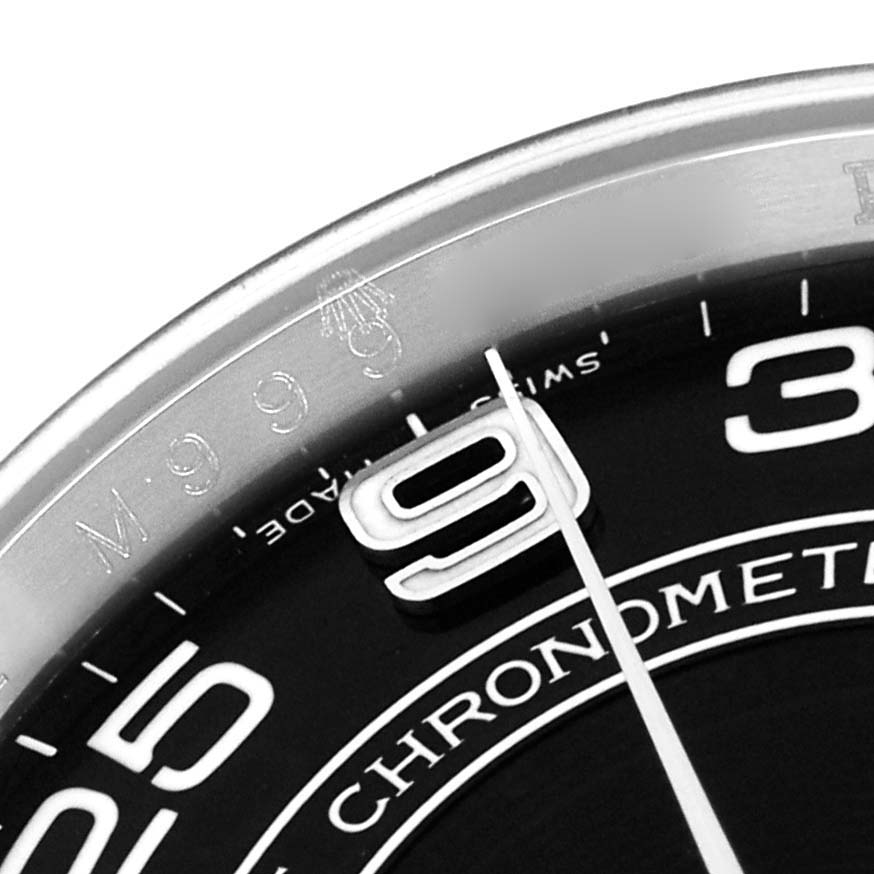 The image shows a close-up angle of the Rolex Oyster Perpetual 116000 Men's Stainless Steel Black Dial's dial, focusing on the numeral "9" and part of the bezel.
