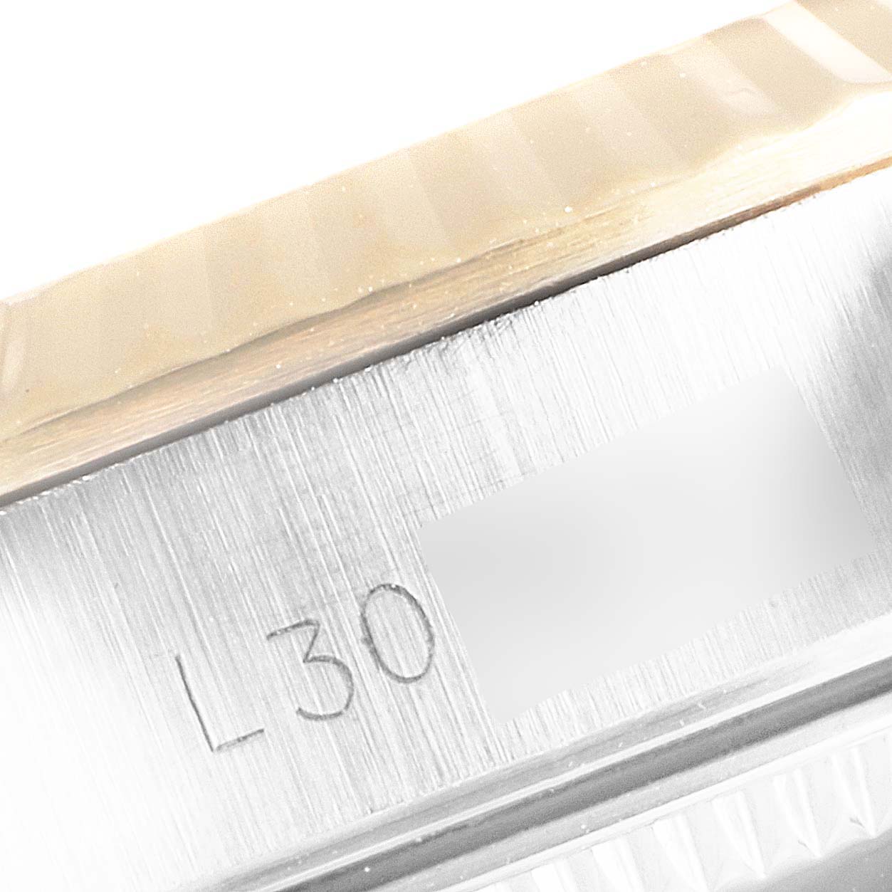 This image shows a close-up of the side bezel and engraved serial number of a Rolex Oyster Perpetual 67193 Women
s Steel and Gold (two tone) Silver Dial 67193 Women
s Steel and Gold (two tone) Silver Dial watch.