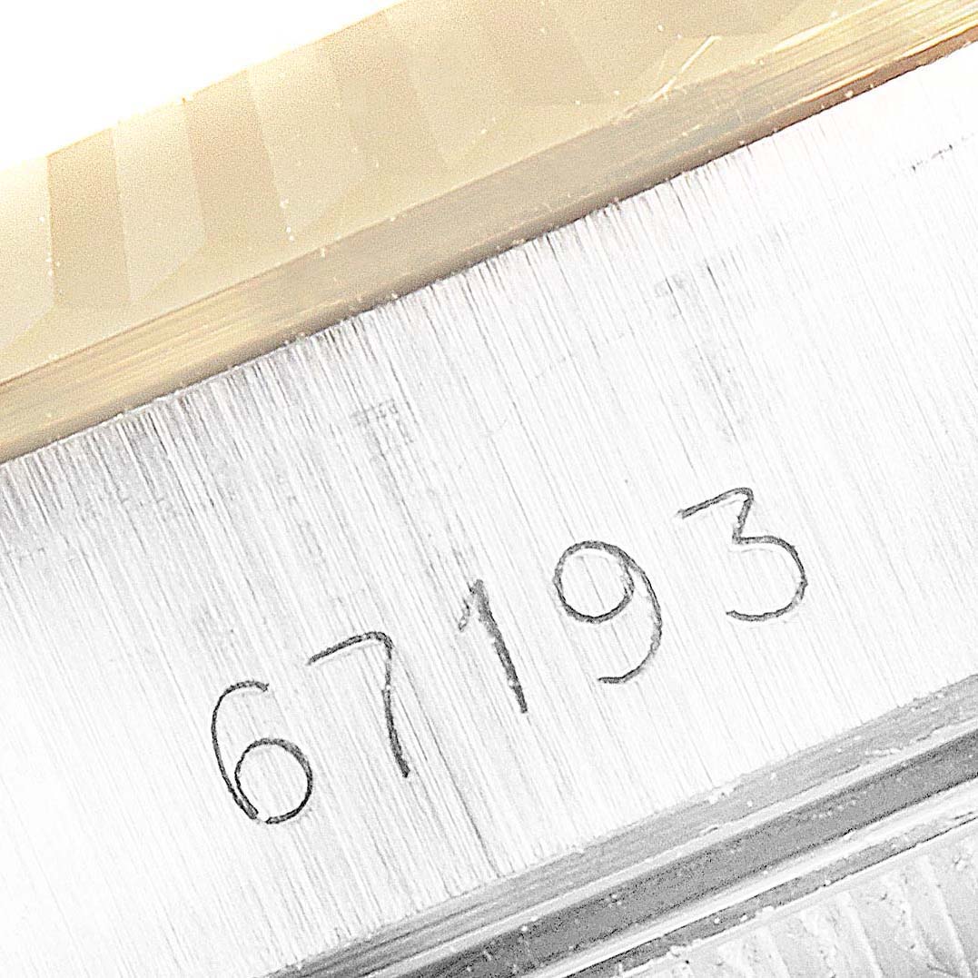 This image shows a close-up of the case and serial number "67193" of the Rolex Oyster Perpetual 67193 Women
s Steel and Gold (two tone) Silver Dial 67193 Women
s Steel and Gold (two tone) Silver Dial watch.