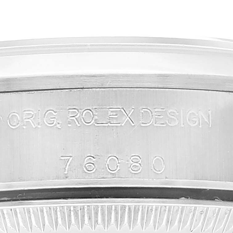 This image shows the side case with engraved serial numbers of an Oyster Perpetual Rolex watch.