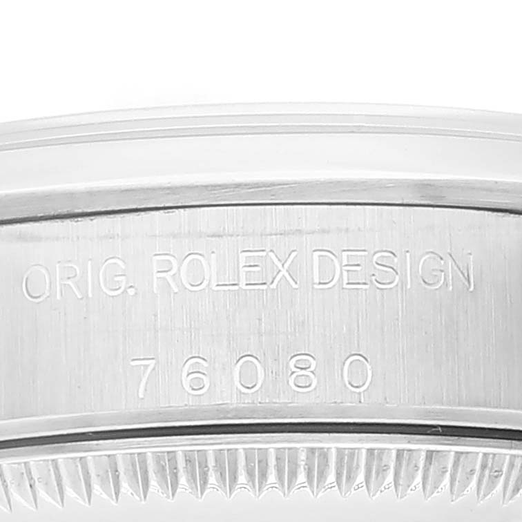The image shows a close-up of the side of the case of a Rolex Oyster Perpetual 76080 Women's Stainless Steel Silver Dial 76080 Women's Stainless Steel Silver Dial watch, displaying the engraved design text and model number "76080."