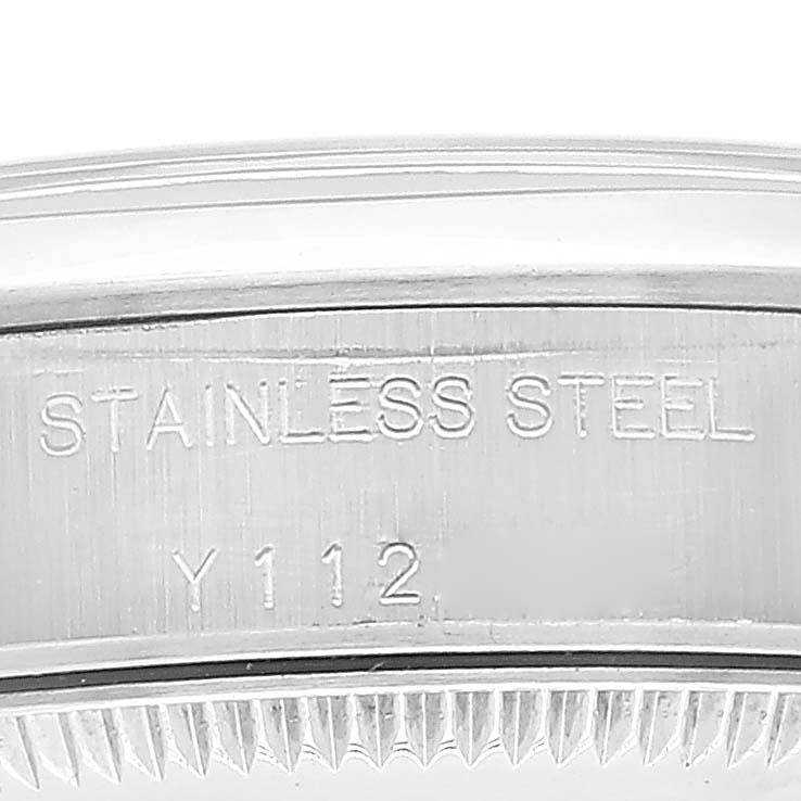 This is a close-up shot of the side of the case of a Rolex Oyster Perpetual 76080 Women's Stainless Steel Silver Dial 76080 Women's Stainless Steel Silver Dial watch, showing the "STAINLESS STEEL" engraving.