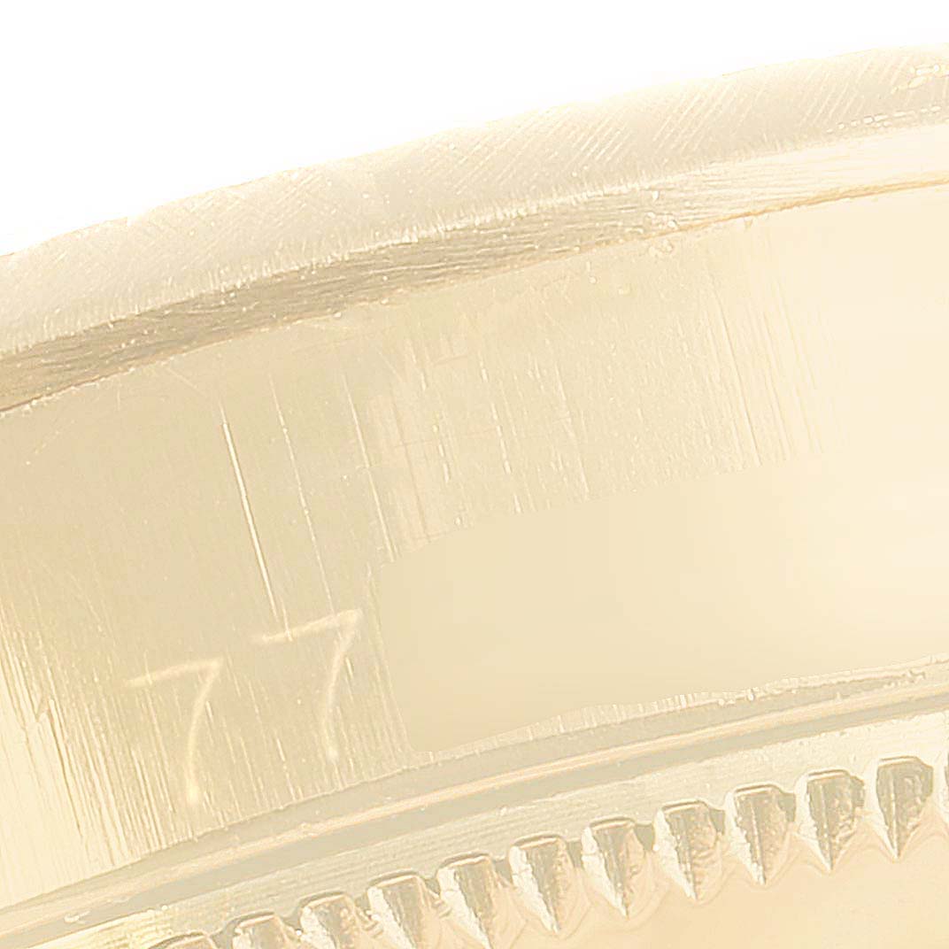 This close-up shows the side edge of a Rolex Oyster Perpetual 6615 Women
s Yellow Gold Silver Dial 6615 Women
s Yellow Gold Silver Dial watch case.
