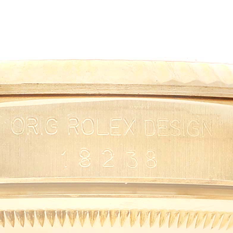 The image shows a close-up angle of the side and edge of a Rolex President 18238 Men's Yellow Gold Champagne Dial 18238 Men's Yellow Gold Champagne Dial watch, with the engravings "ORIG ROLEX DESIGN 18238."