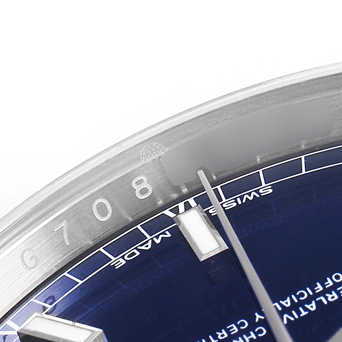 The image shows a close-up of the bezel and part of the dial of a Rolex President 118139 Men's White Gold Blue Dial 118139 Men's White Gold Blue Dial model watch, highlighting the serial number and "Swiss Made" text.