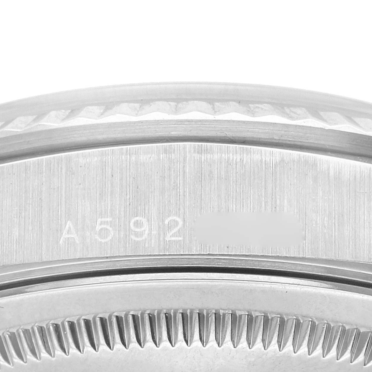 This image shows a close-up of the side of a Rolex President 18239 Men's White Gold Silver Dial 18239 Men's White Gold Silver Dial watch, focusing on the serial number and part of the bezel.