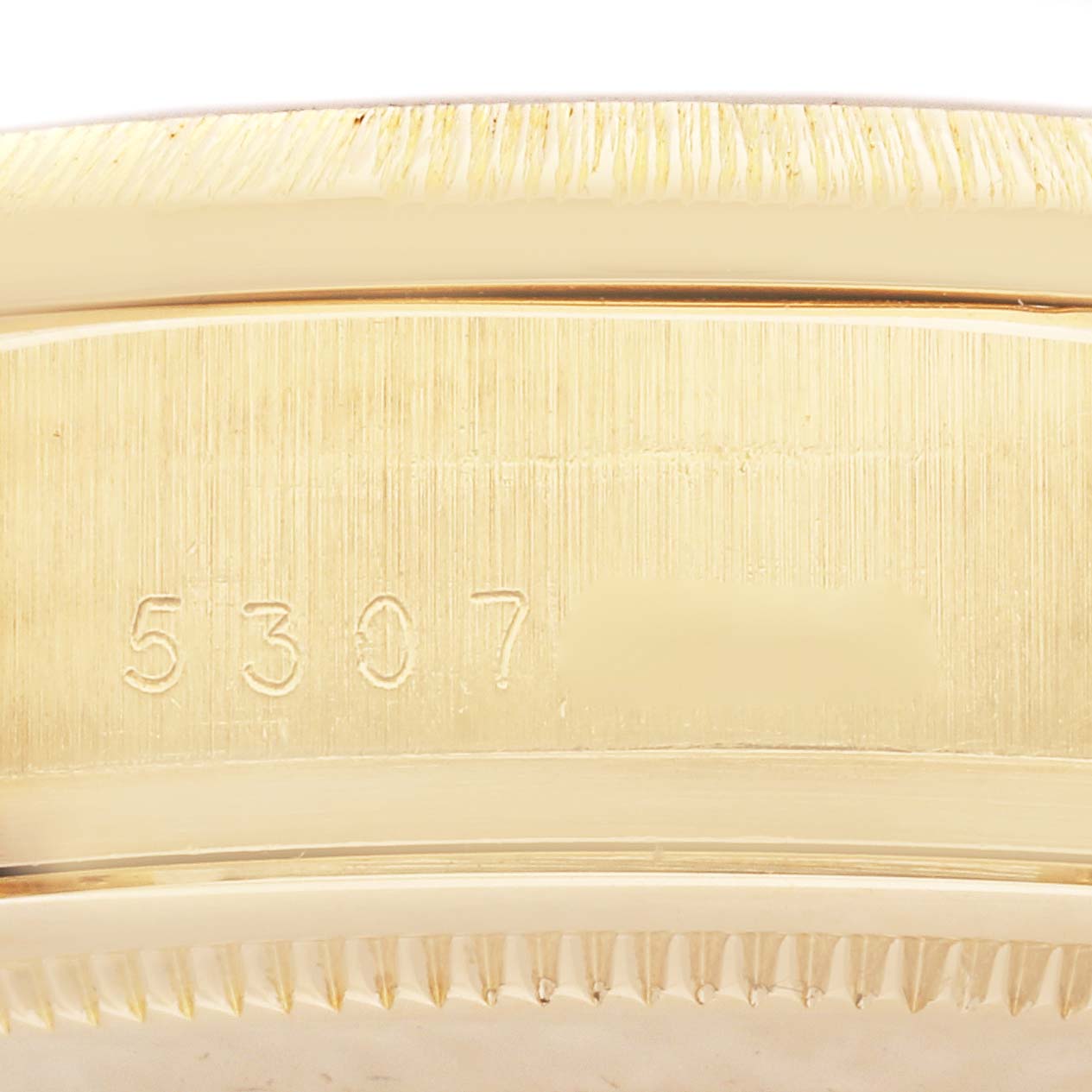 This close-up image shows the engraved serial number on the case of a Rolex President 18078 Men
s Yellow Gold Champagne Dial 18078 Men
s Yellow Gold Champagne Dial model watch.