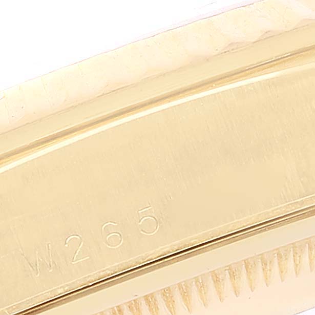 The image shows a close-up of the side of the Rolex President 18238 Men's Yellow Gold Champagne Dial 18238 Men's Yellow Gold Champagne Dial watch case, featuring an engraved serial number.