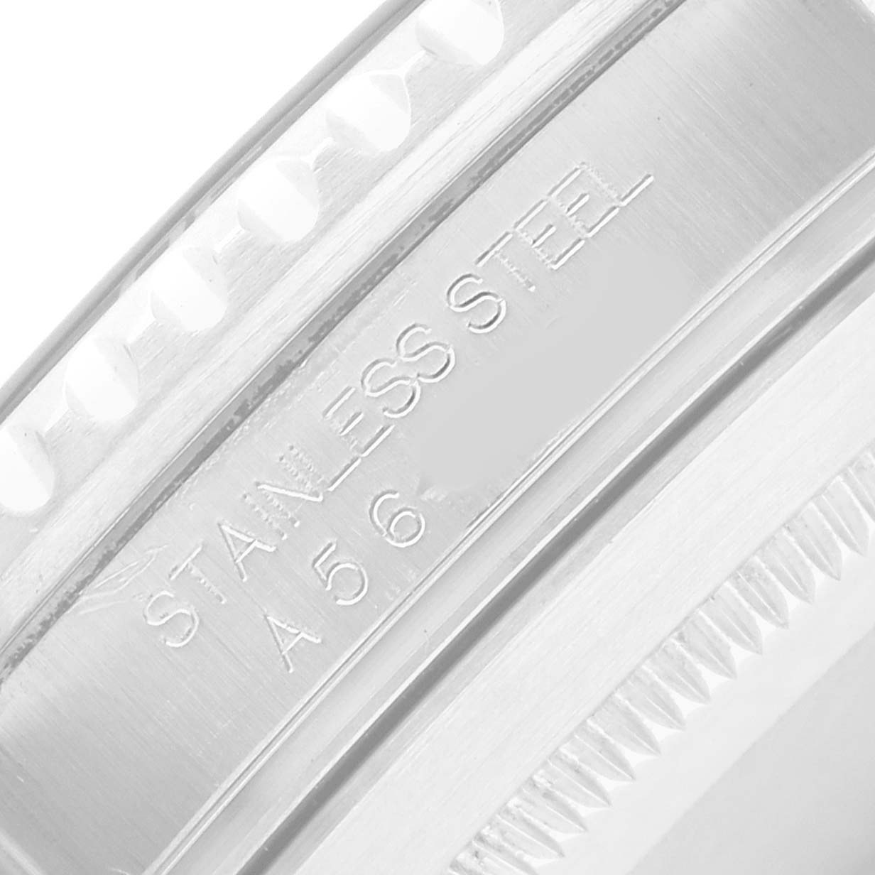 The image shows a close-up of the side of a Rolex Submariner 16610 Men's Stainless Steel Black Dial watch, highlighting the stainless steel material and engravings.