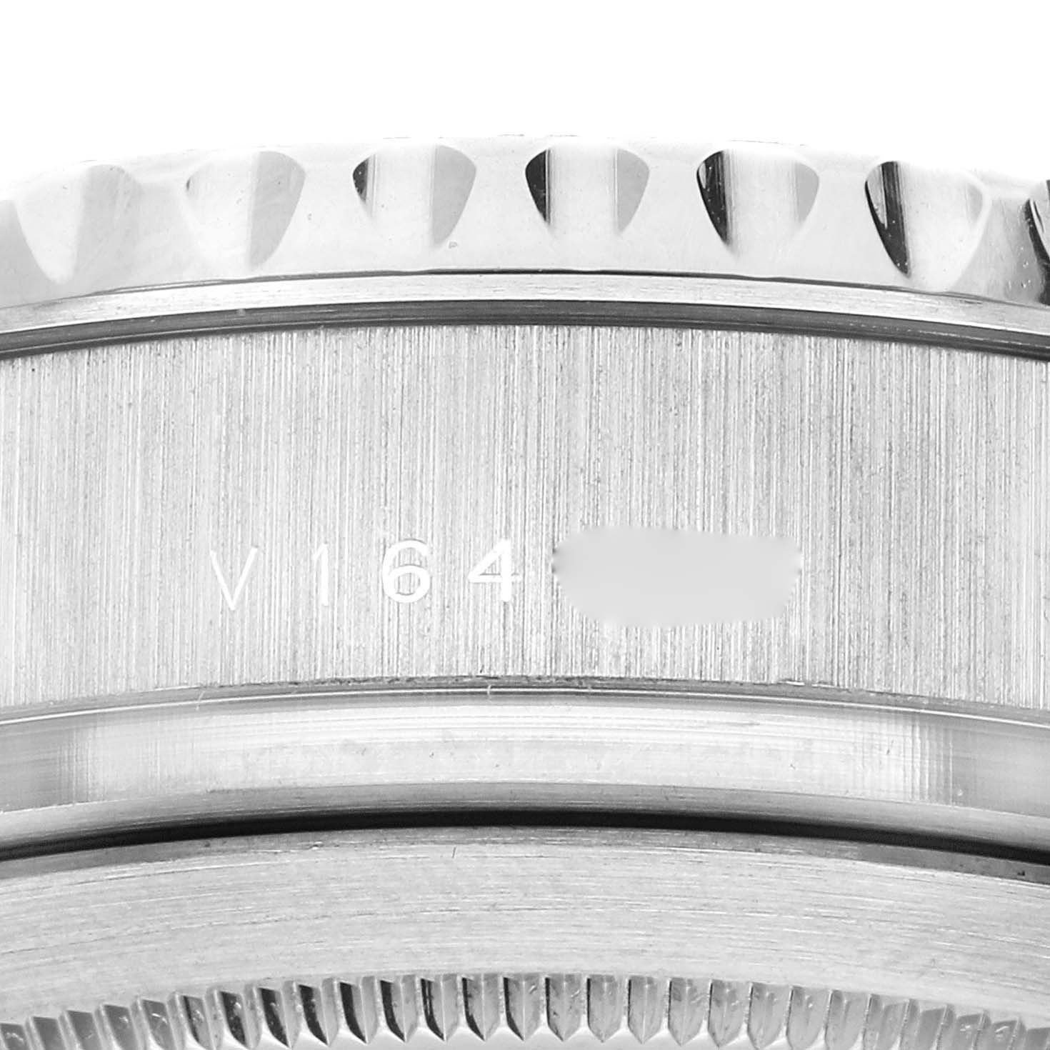The image showcases a close-up of the serial number engraving and bezel teeth of a Rolex Yacht-Master 116689 Men's White Gold White Dial 116689 Men's White Gold White Dial watch.