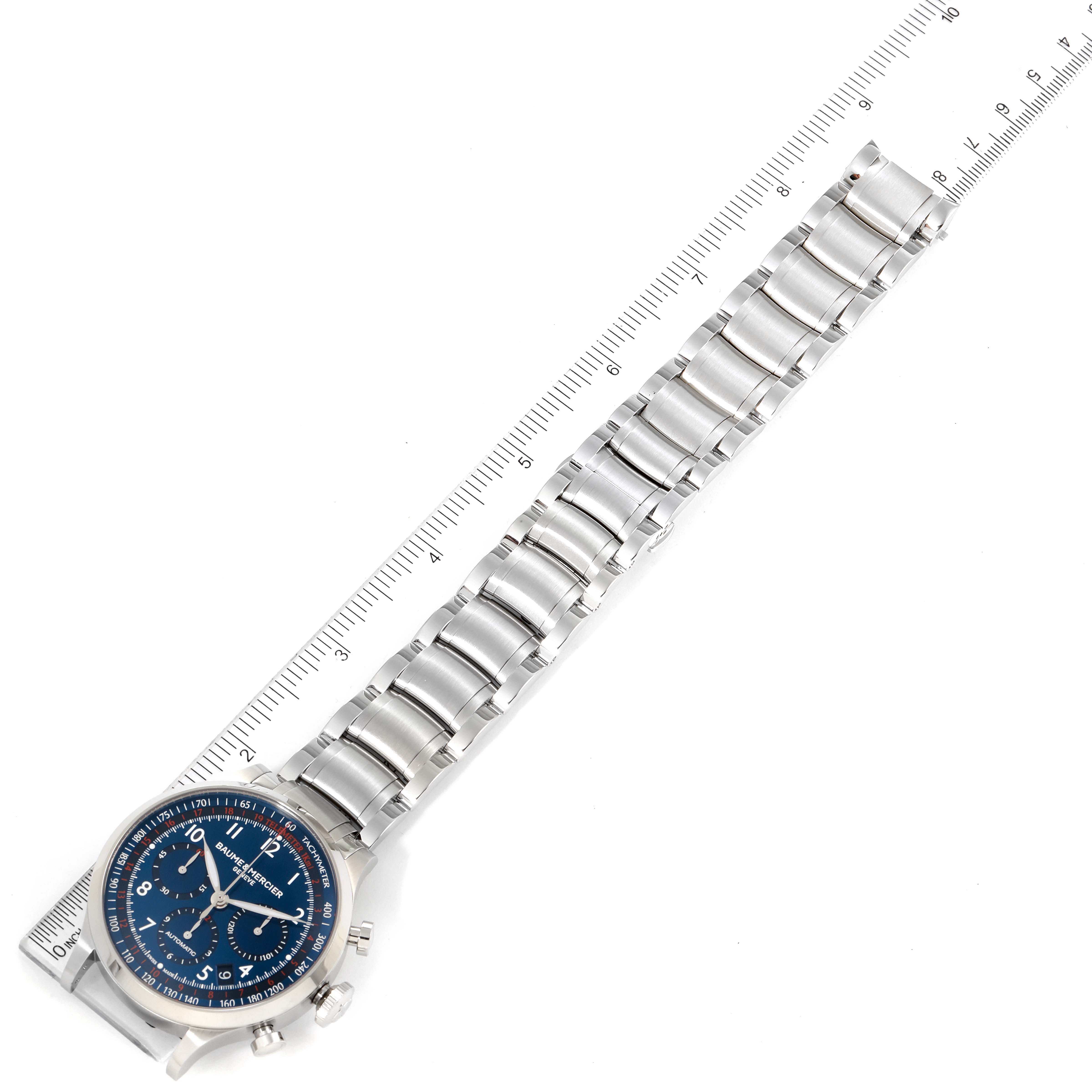 The image shows a Baume & Mercier Capeland 10066 Men's Stainless Steel Blue Dial 10066 Men's Stainless Steel Blue Dial watch laid flat, highlighting its blue dial and metal bracelet from an overhead angle.