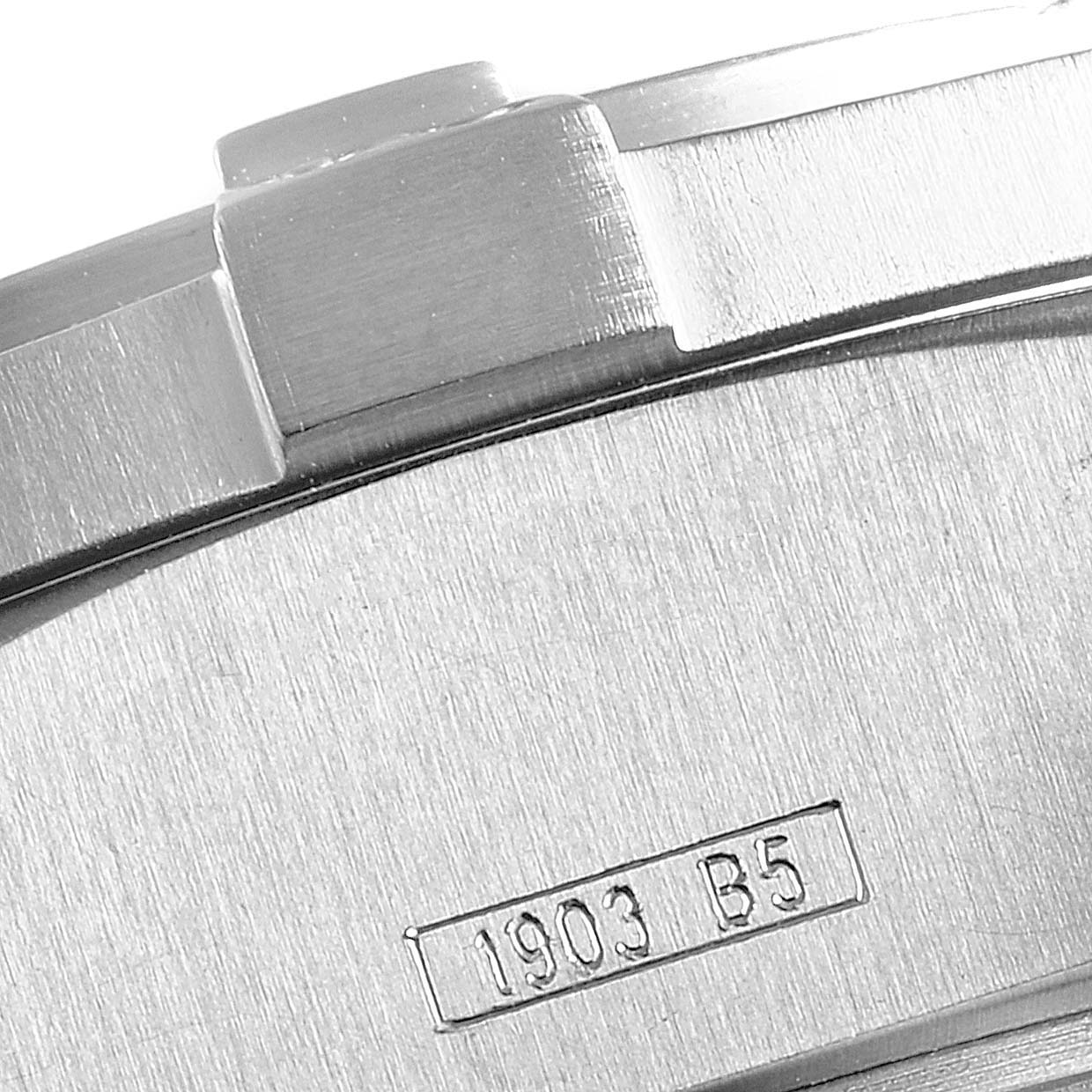 This close-up image shows the engraved case back and part of the bezel of a Breitling Avenger E73360 Men's Titanium Yellow Dial E73360 Men's Titanium Yellow Dial watch.