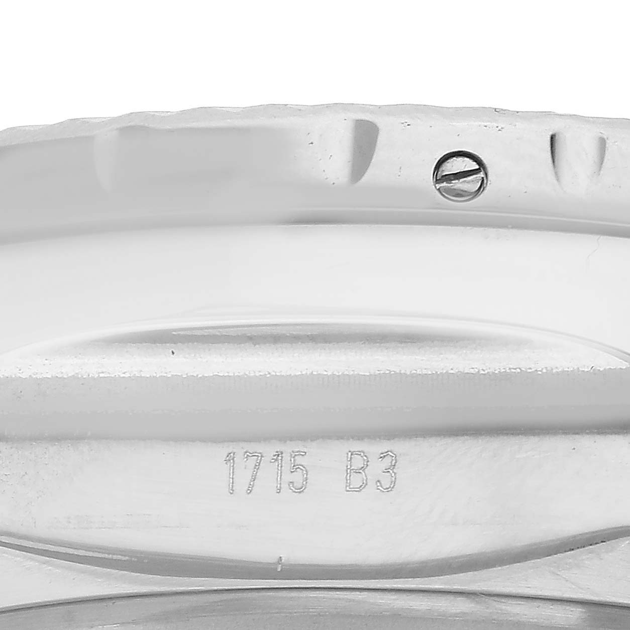 The image shows the side view of a Bentley model Breitling watch, focusing on the bezel and case's serial engraving.