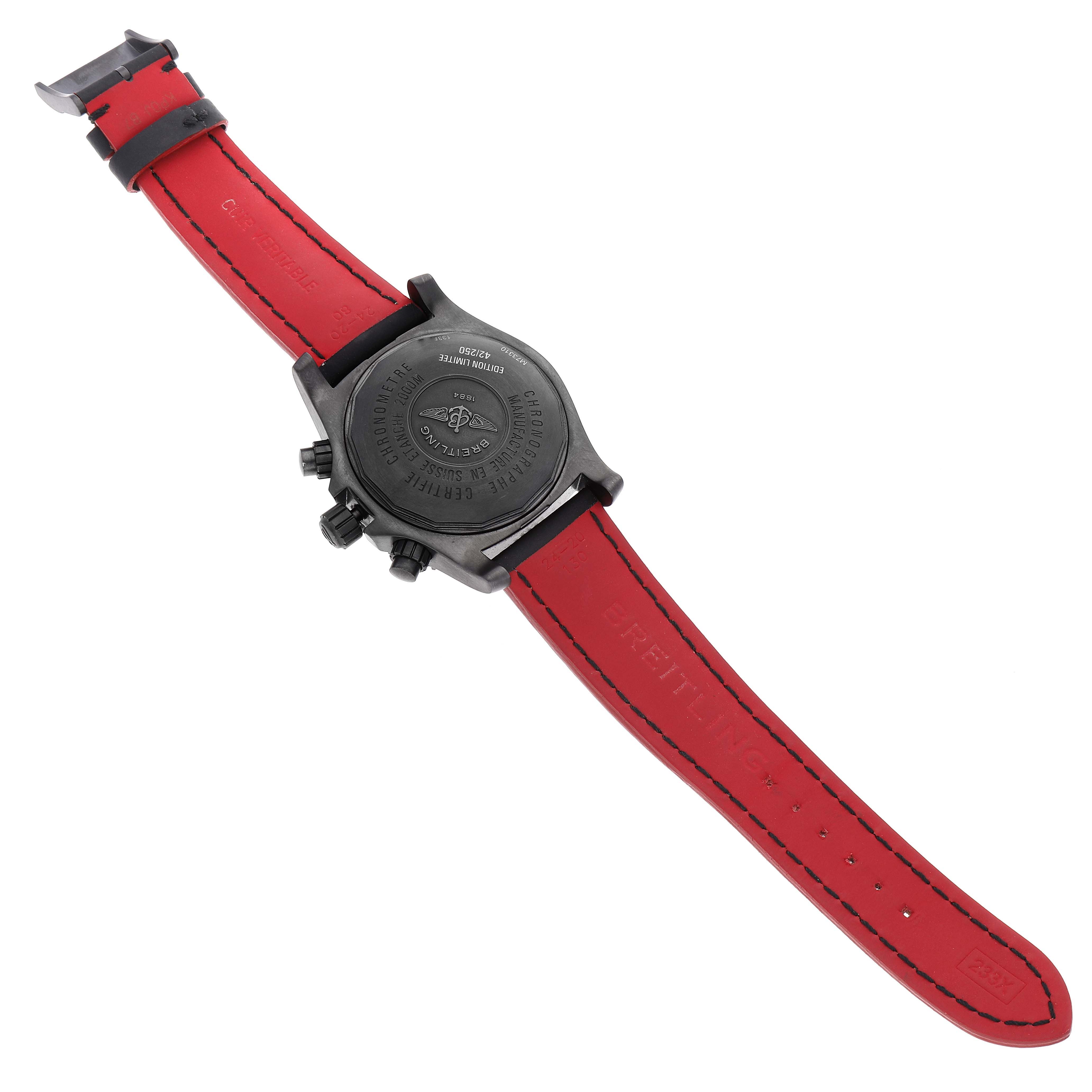 The image shows the back of a Breitling Superocean M73310B7 Men's Stainless Steel Black Dial M73310B7 Men's Stainless Steel Black Dial watch with a red strap laid out flat.