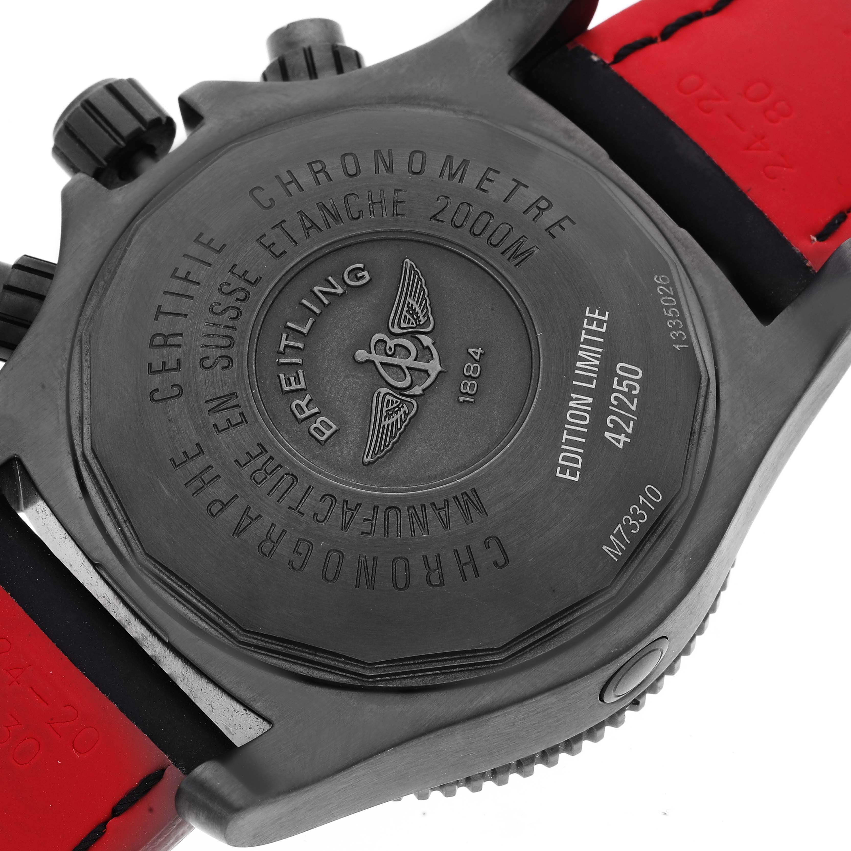 This image shows the back of the Breitling Superocean M73310B7 Men's Stainless Steel Black Dial M73310B7 Men's Stainless Steel Black Dial watch with its engraved details and part of the red strap.