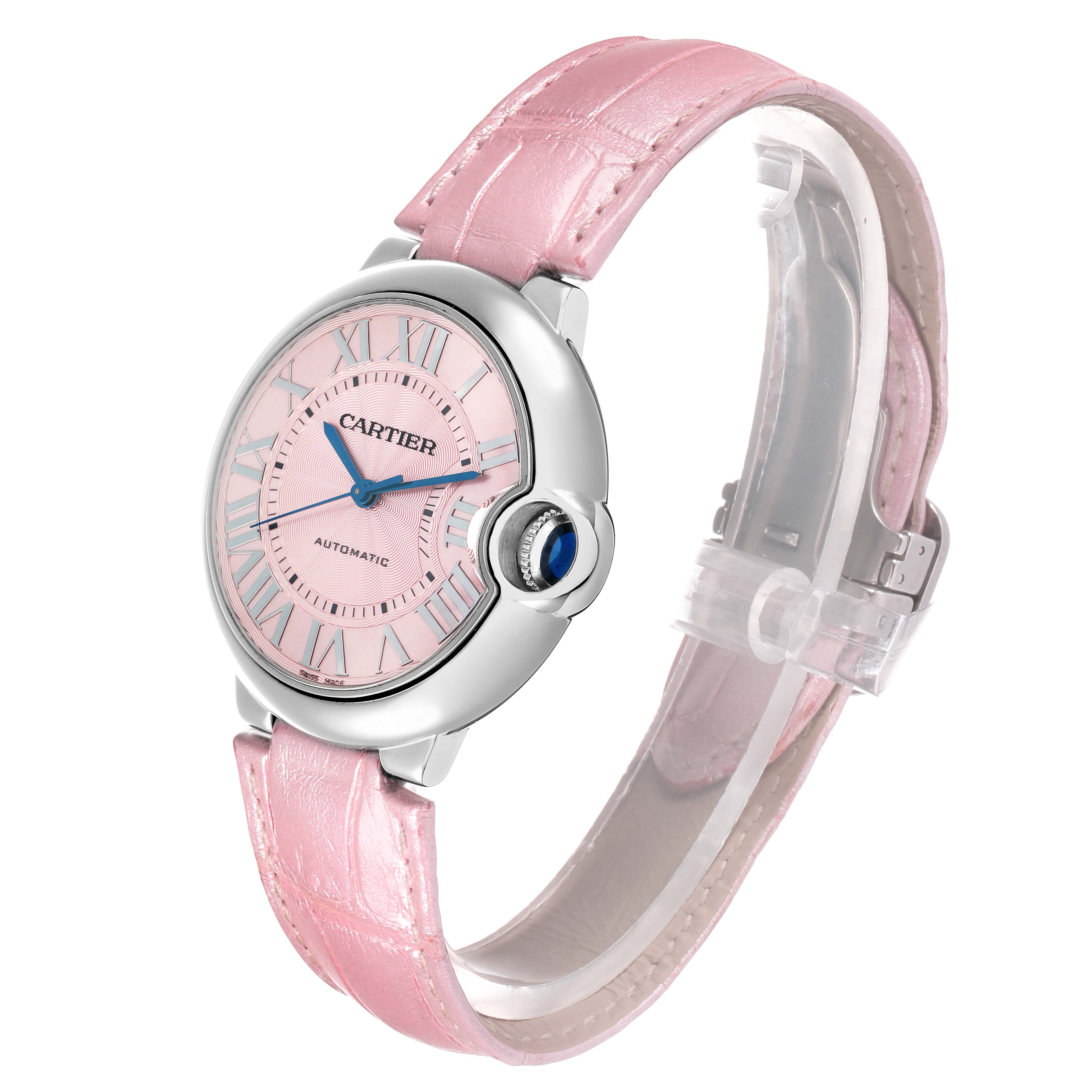 The Cartier Ballon Bleu WSBB0007 Women
s Stainless Steel Pink Dial watch is shown at a three-quarter angle, highlighting its pink dial, leather strap, case, and crown.
