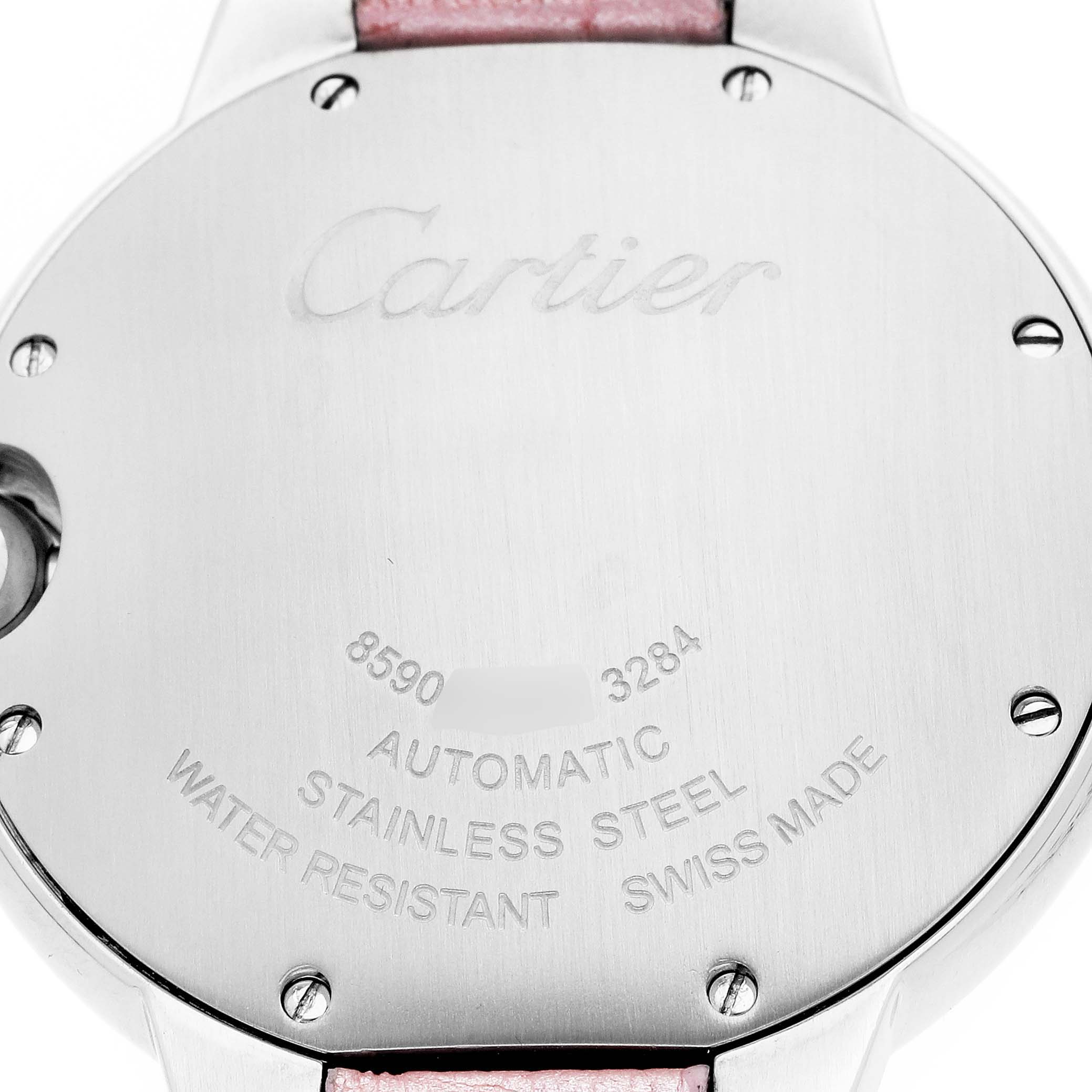 The image shows the back case of a Ballon Bleu model by Cartier, featuring engraved details and a glimpse of a pink strap.
