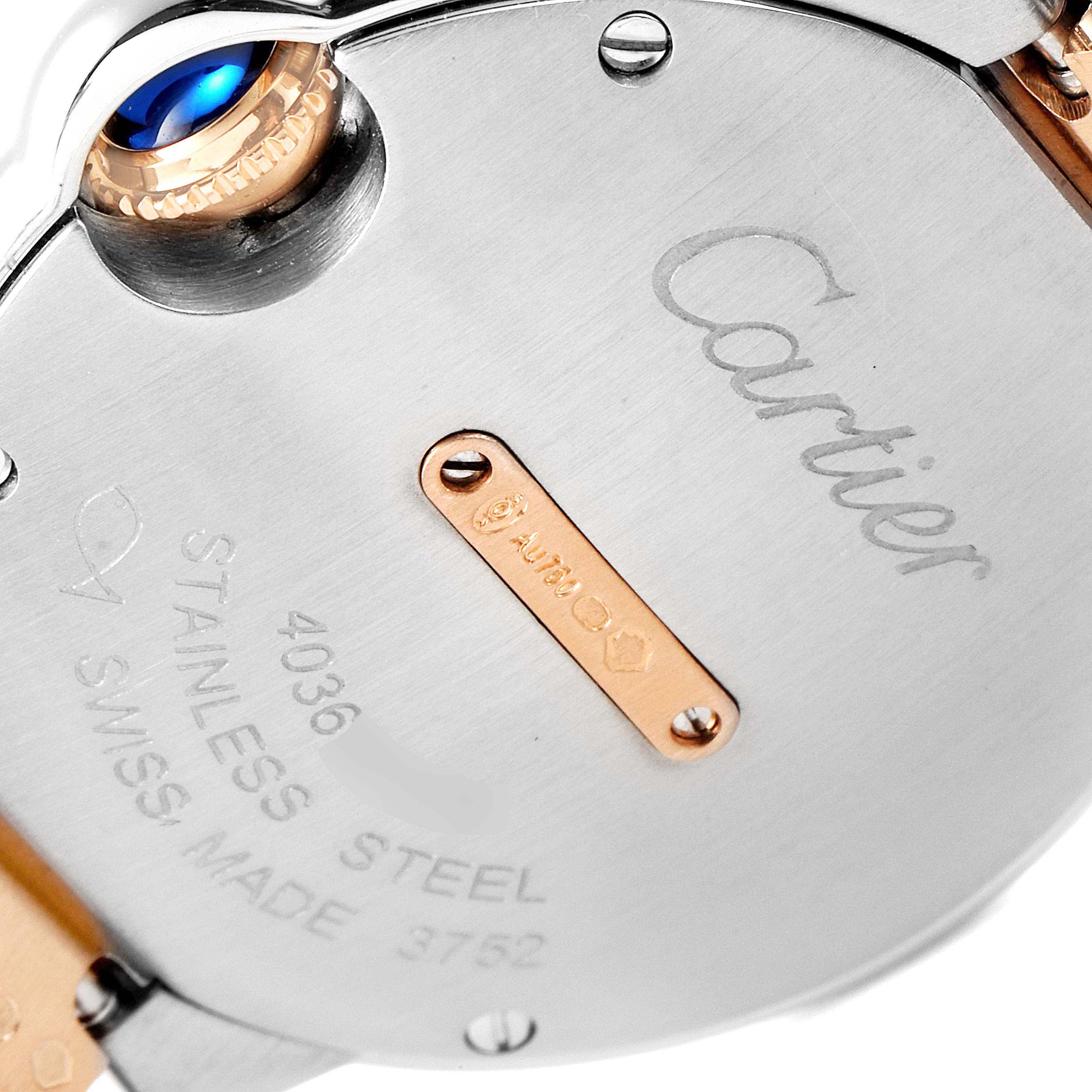 The image shows the back and crown of the Ballon Bleu watch by Cartier, highlighting the engraved brand name and material details.