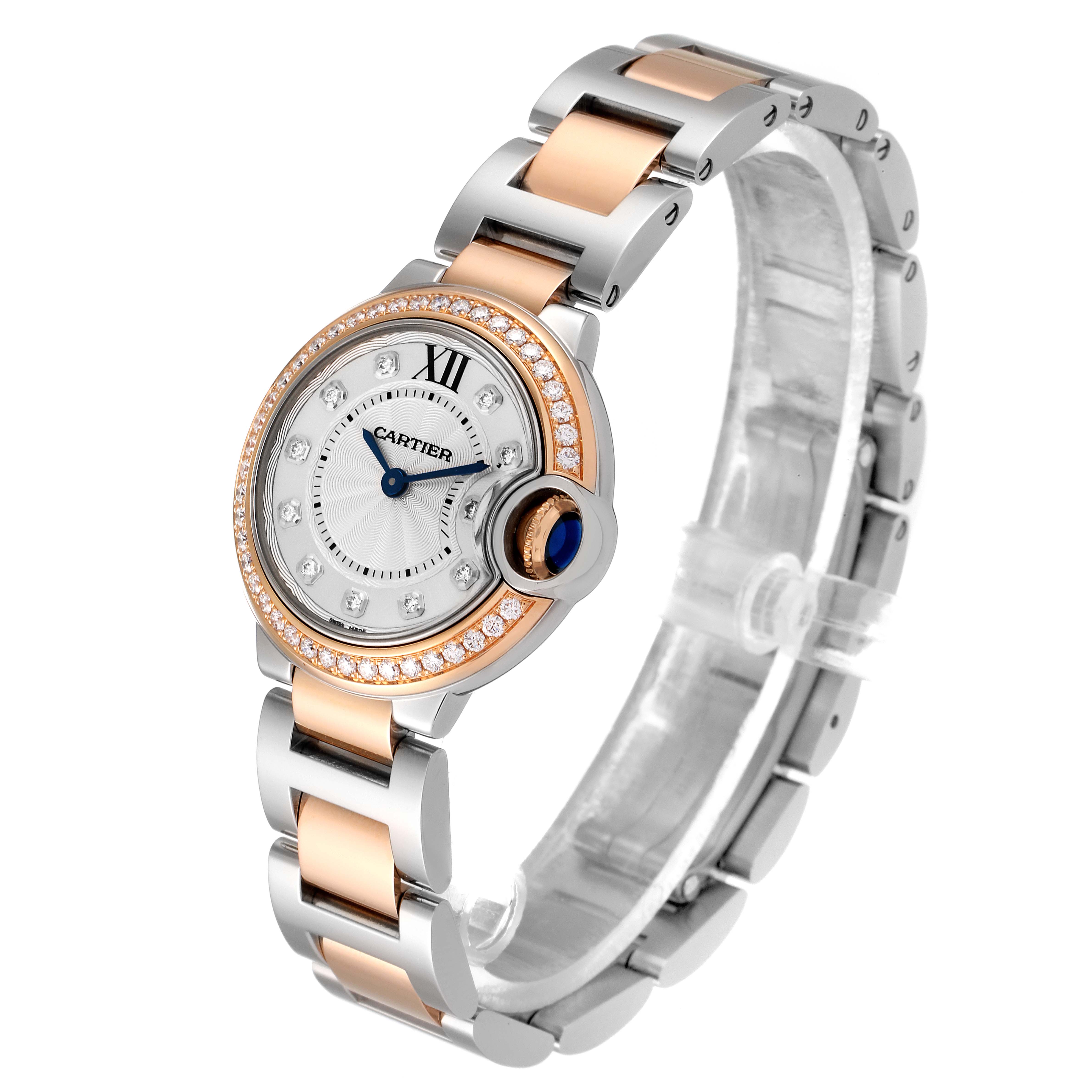 The Ballon Bleu de Cartier watch is shown at an oblique angle, highlighting its round face, diamond bezel, and two-tone bracelet.