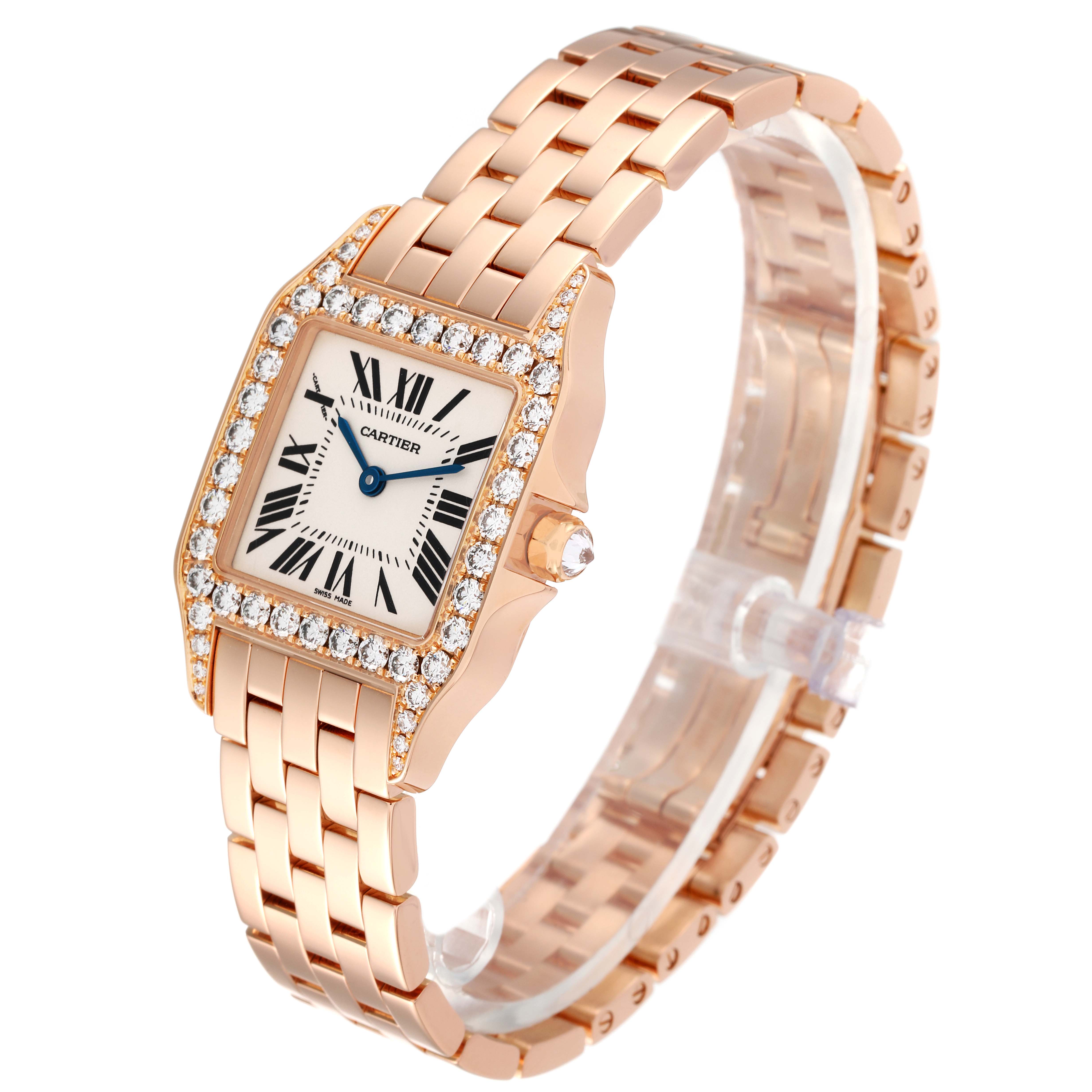 The Cartier Santos Demoiselle WF9007Z8 Women's Rose Gold Silver Dial WF9007Z8 Women's Rose Gold Silver Dial watch is shown at a front-left angle, highlighting its diamond bezel, square face, and metal bracelet.