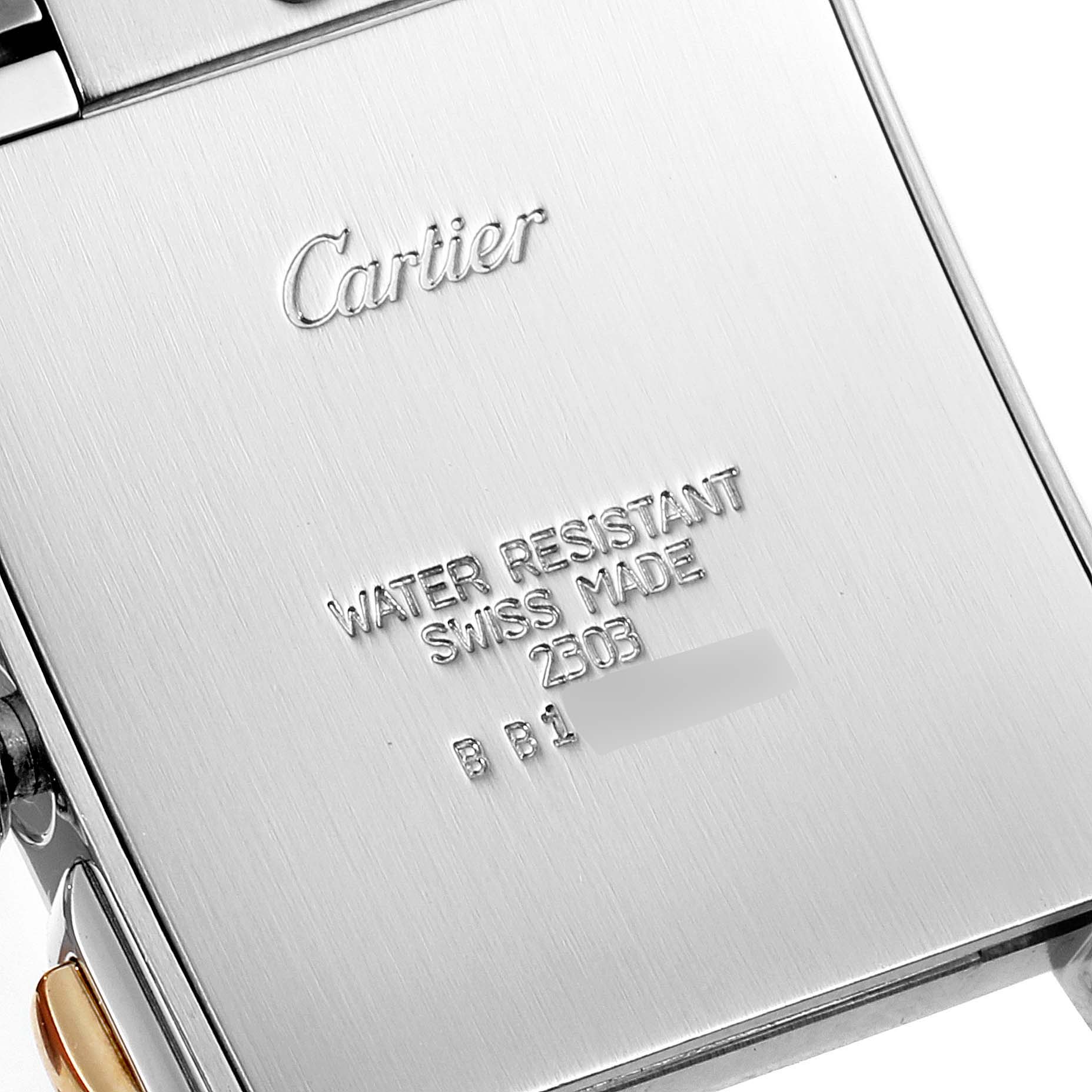This image shows a close-up of the back case of a Cartier Tank Francaise W51004Q4 Men's Steel and Gold (two tone) Silver Dial W51004Q4 Men's Steel and Gold (two tone) Silver Dial watch, highlighting the engravings.