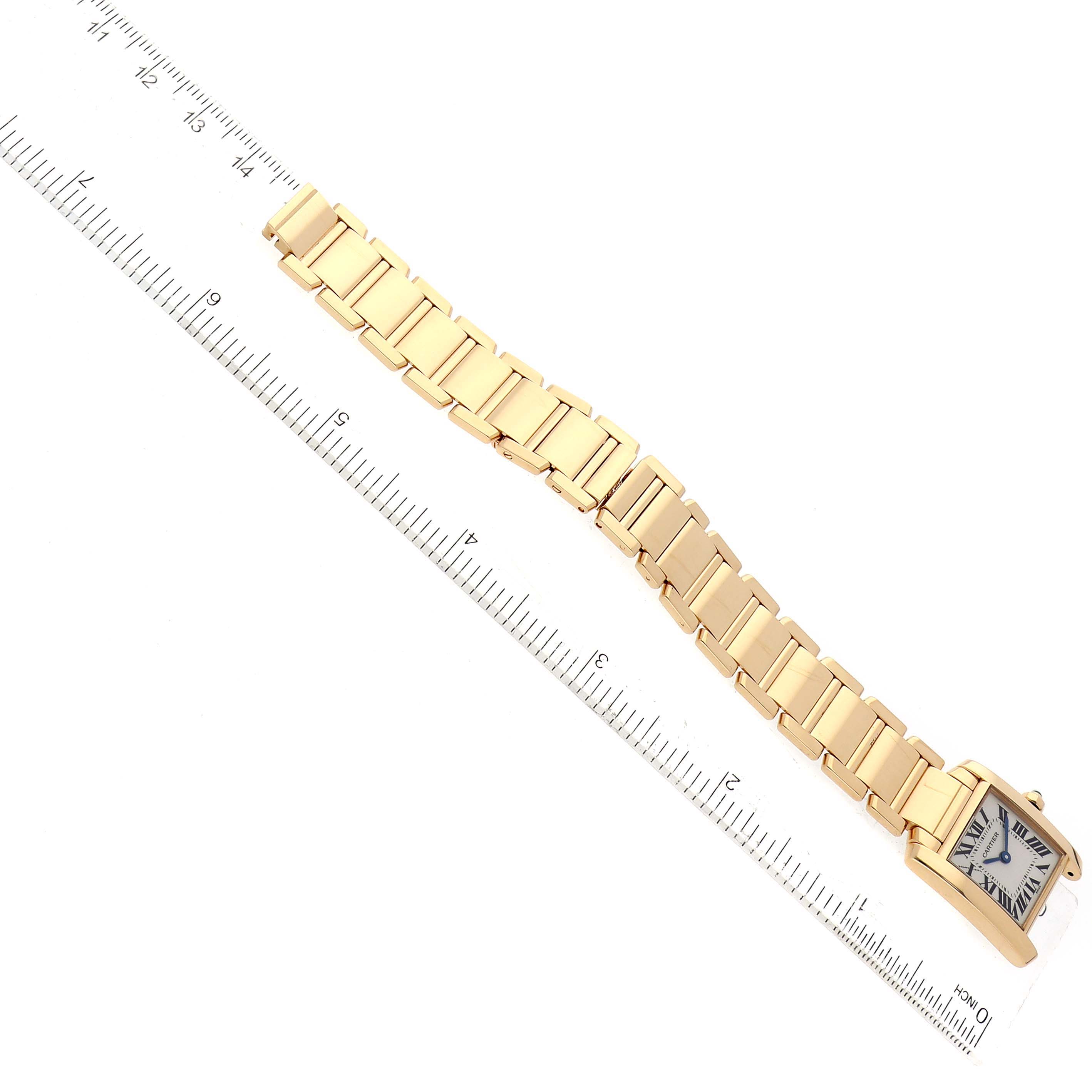 The Cartier Tank Francaise W50002N2 Women's Yellow Gold Silver Dial W50002N2 Women's Yellow Gold Silver Dial watch is shown from a top-down angle, highlighting the full length of its gold bracelet and face.