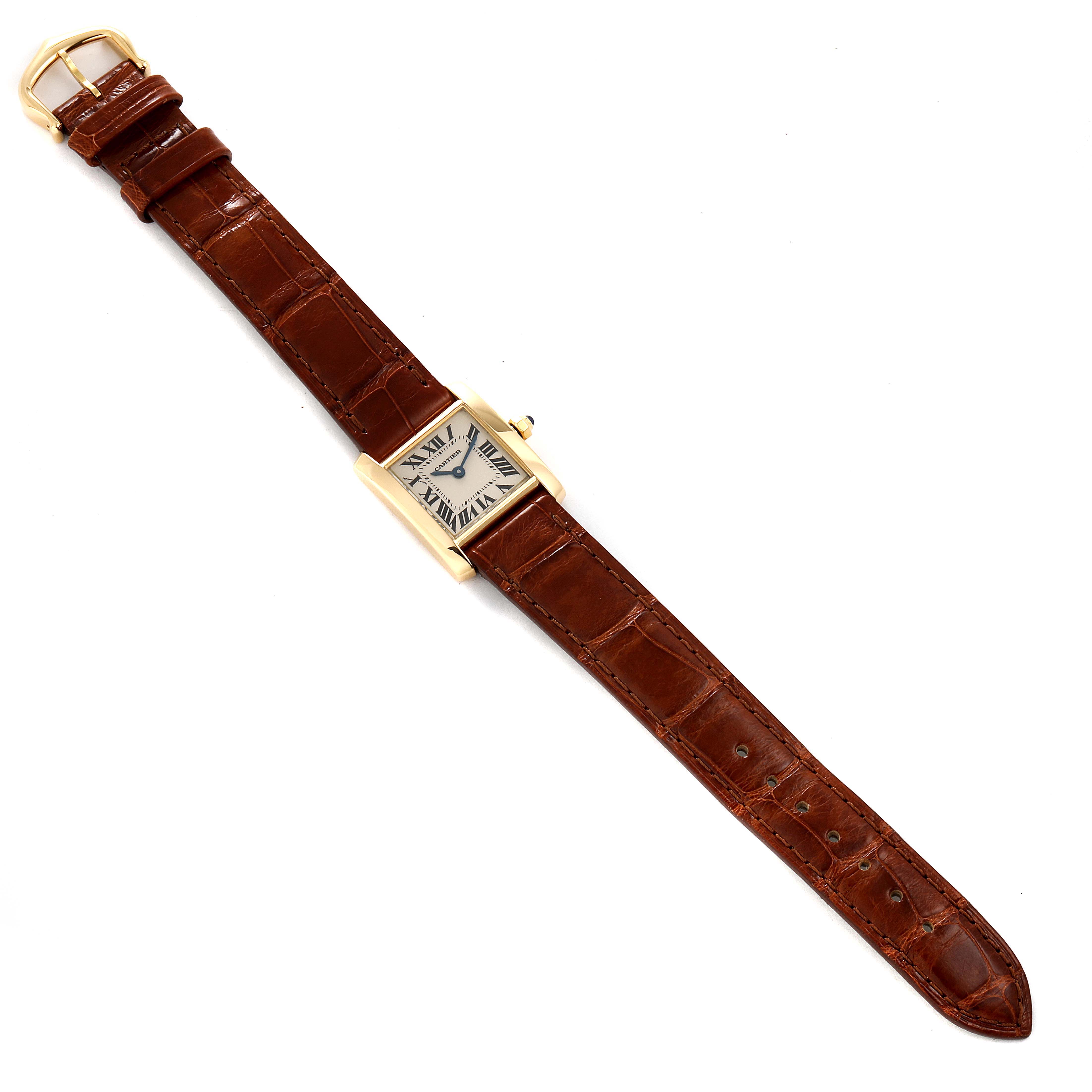The image shows a full view of a Cartier Tank Française watch with a brown leather strap, displayed flat from an overhead angle.