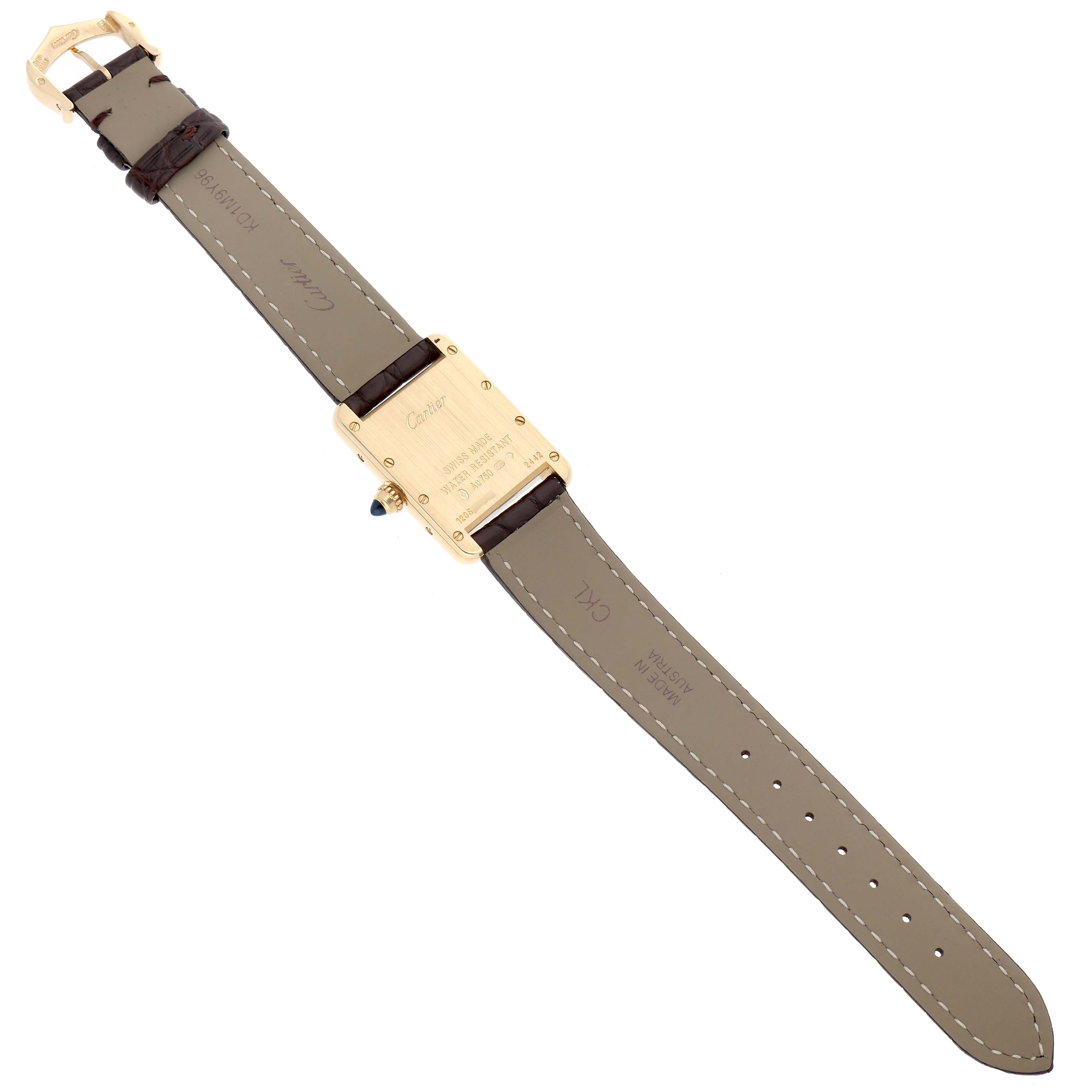 The Cartier Tank Louis W1529856 Women
s Yellow Gold Silver Dial watch is shown from the back, displaying the strap, buckle, and case back with engravings.