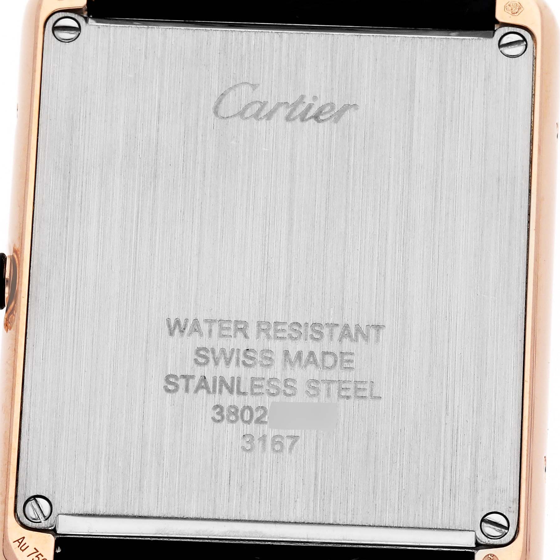 This image shows the back case of a Cartier Tank Solo W5200025 Men's Steel and Gold (two tone) Silver Dial W5200025 Men's Steel and Gold (two tone) Silver Dial watch, including engraved details, screws, and part of the strap.