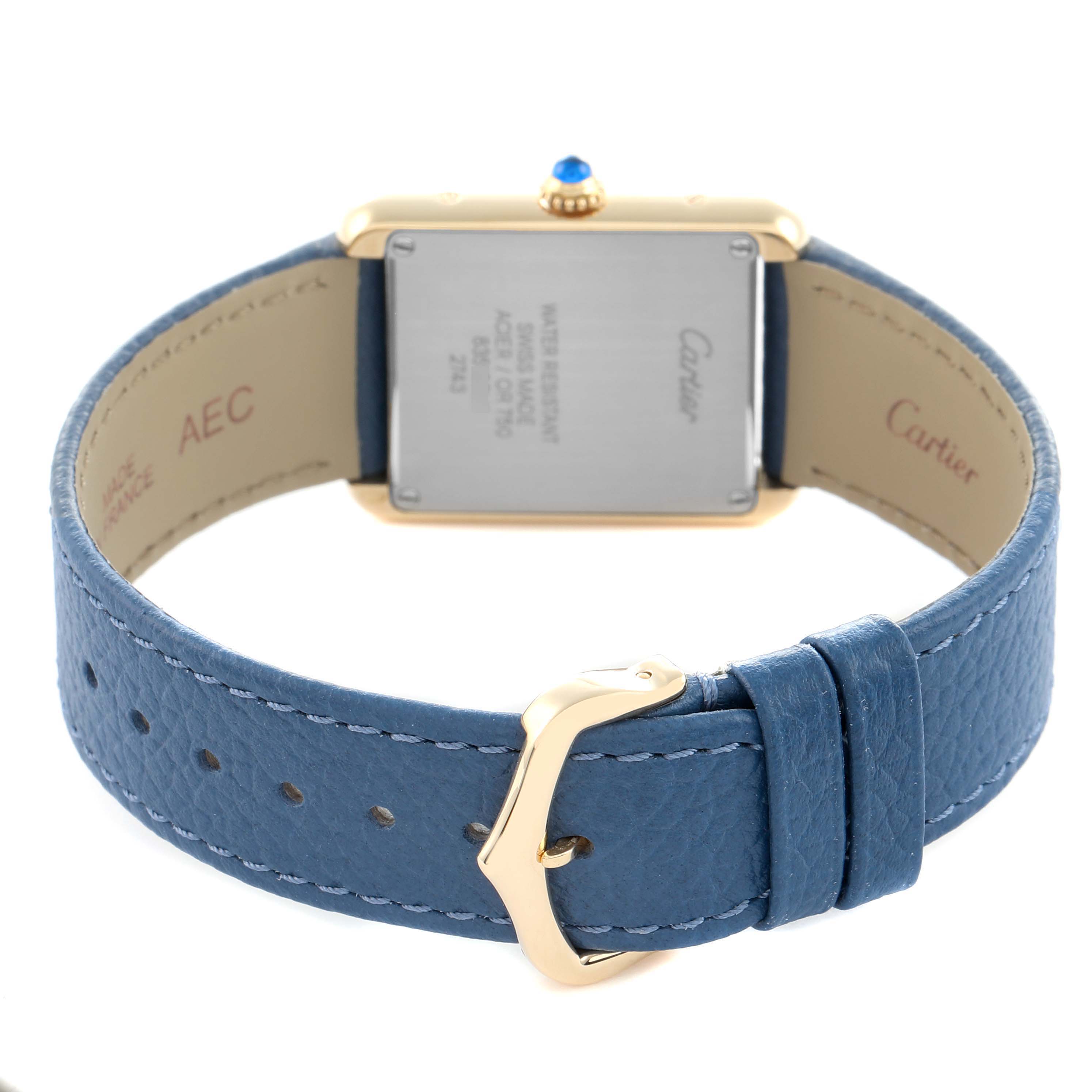 The image shows the back view of a Cartier Tank Solo W1018755 Women
s Steel and Gold (two tone) Silver Dial watch with a blue leather strap and gold buckle.