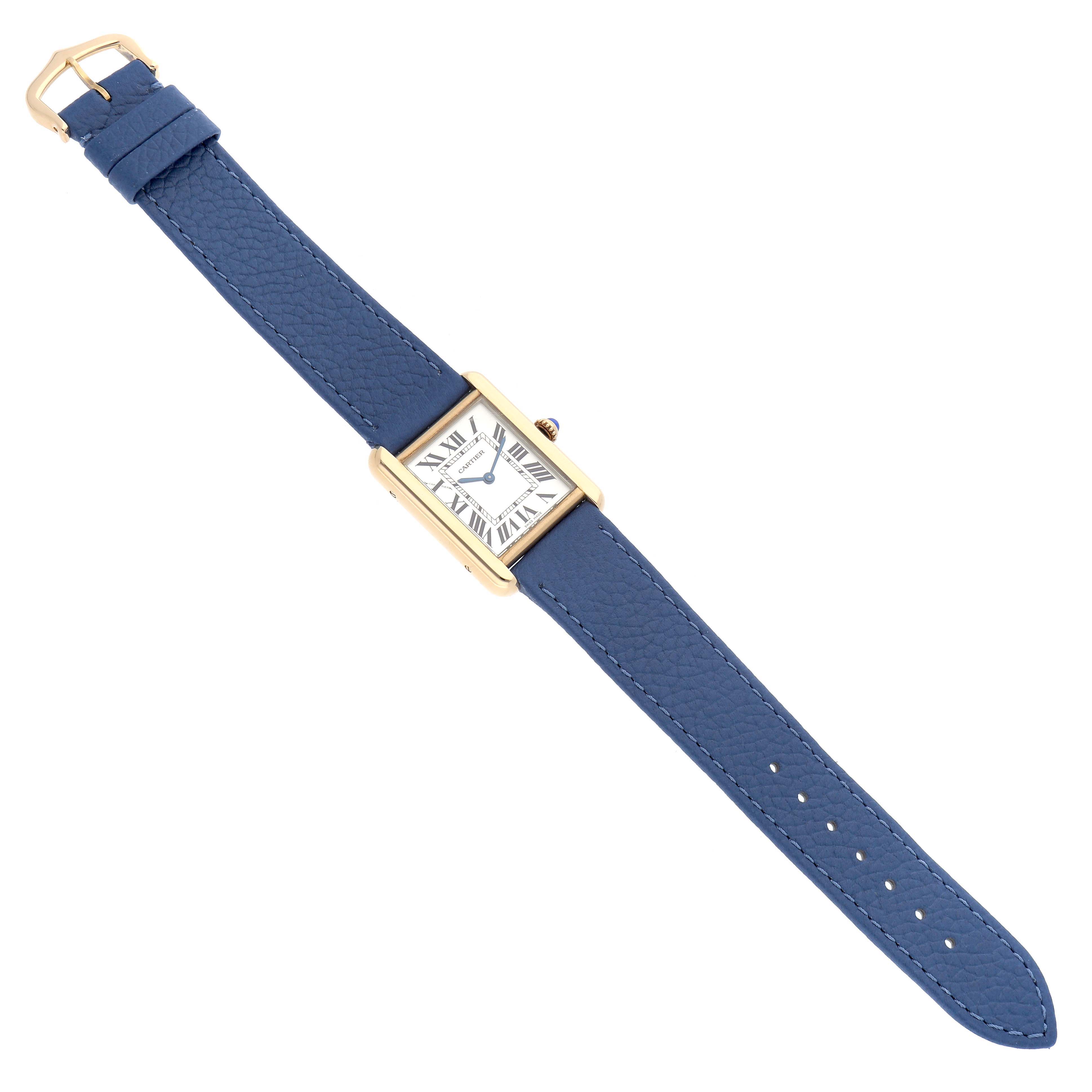 The image shows a Cartier Tank Solo W1018755 Women
s Steel and Gold (two tone) Silver Dial watch from a top-down angle, featuring its blue leather strap and rectangular dial.