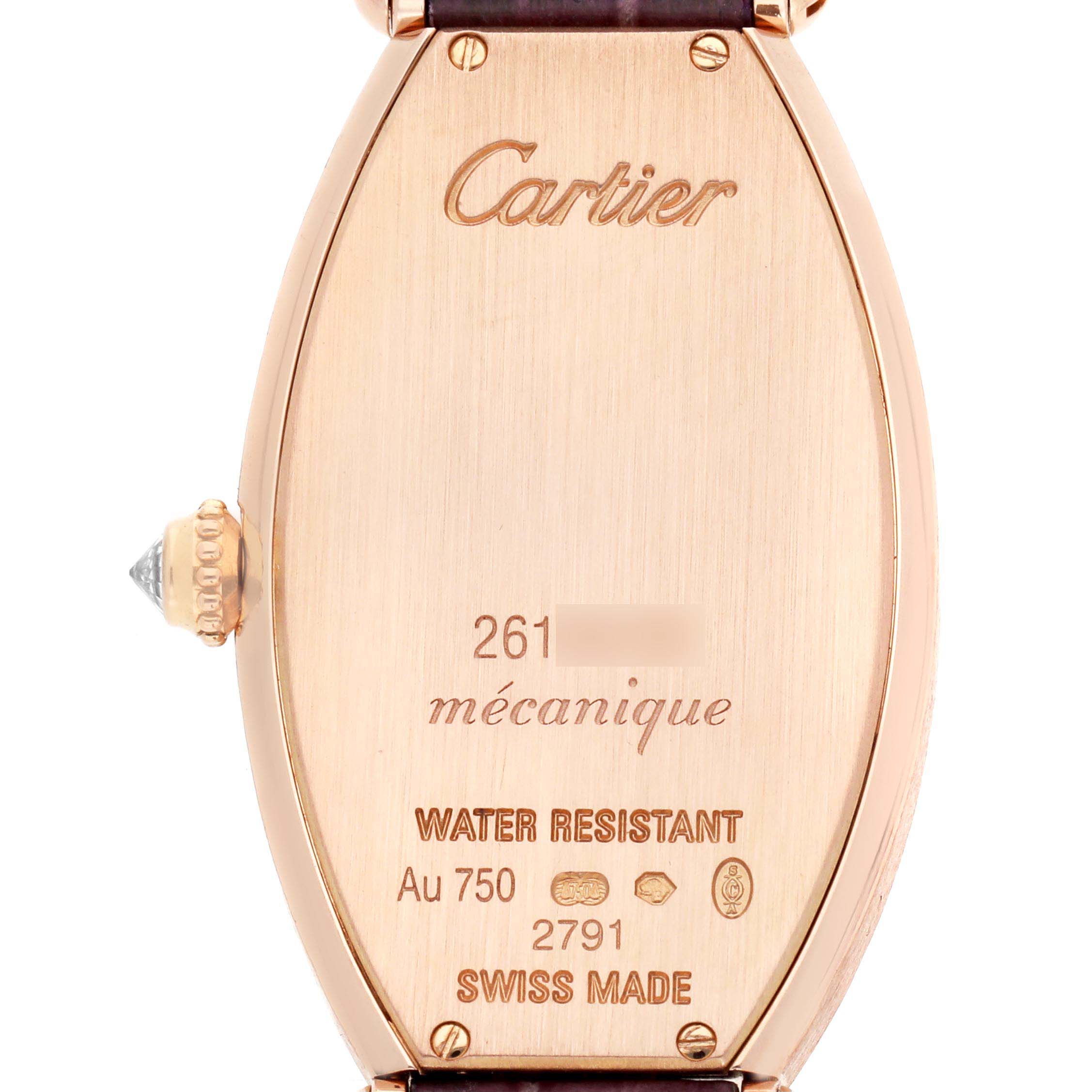 The image shows the back of a Cartier Tonneau WE400331 Women's Rose Gold Silver Dial watch featuring engravings and a visible crown.