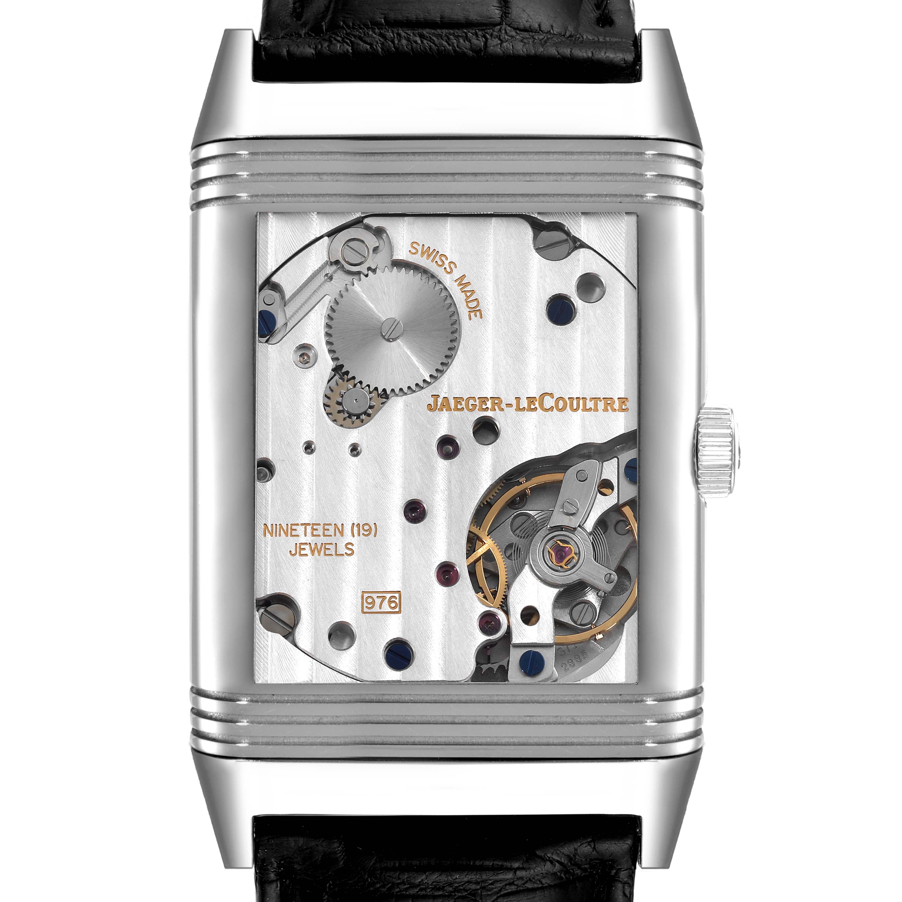 This image shows a Reverso model watch by Jaeger LeCoultre from the back, revealing its inner mechanical parts and movement.
